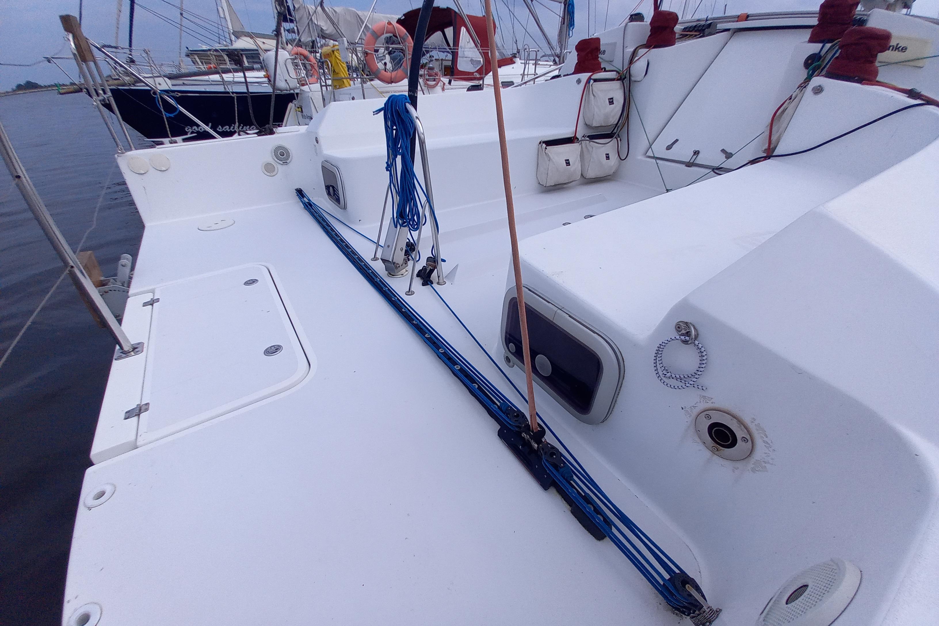 Sailboat deck of 2017 Pogo 12.50 with ropes and equipment in marina setting.