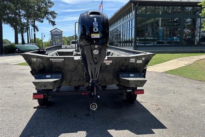 2026 Tracker Grizzly 2072 CC boat with 150 HP engine, parked outdoors.
