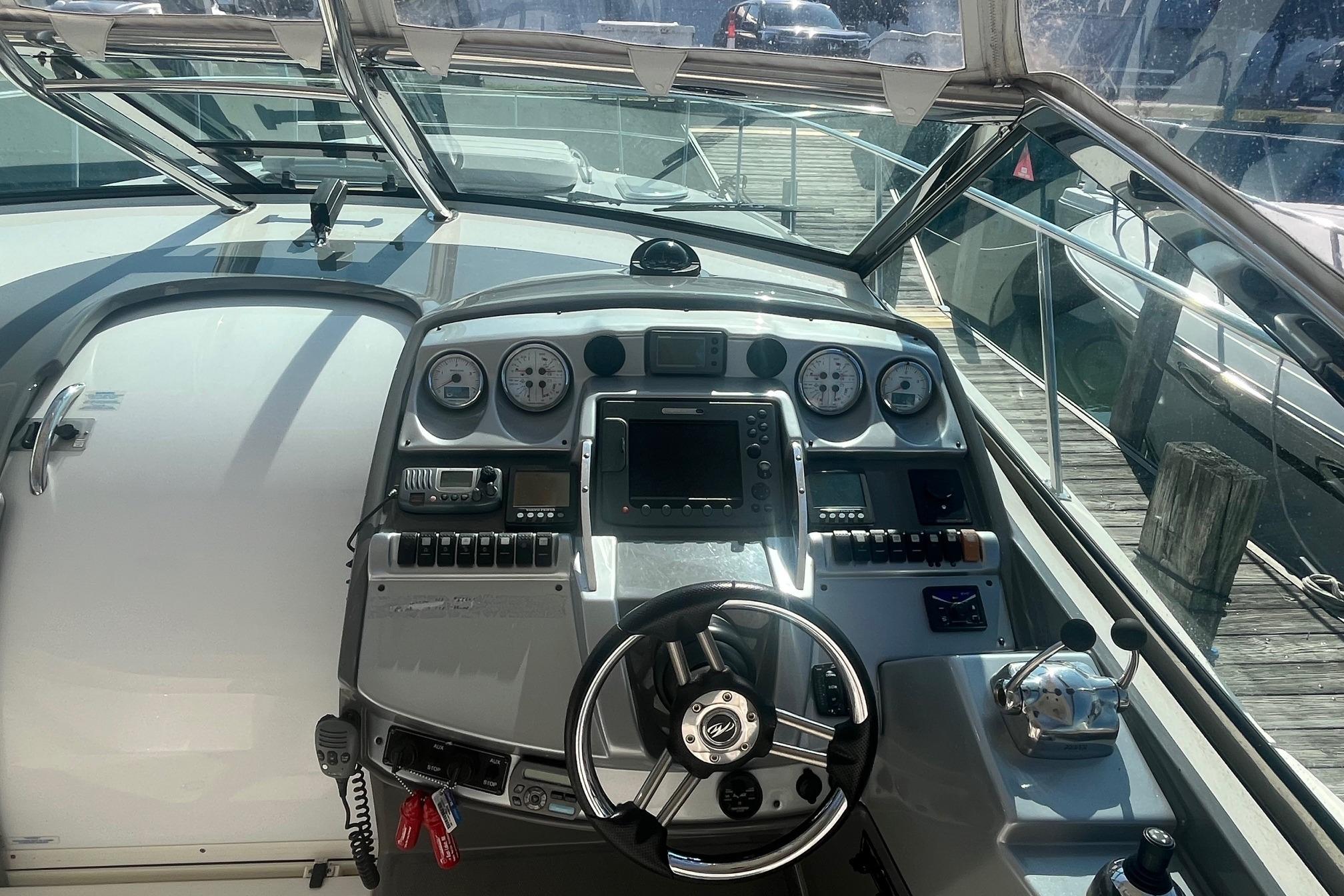 Cockpit of 2010 Monterey 400 Sport Yacht with steering wheel and control panel.