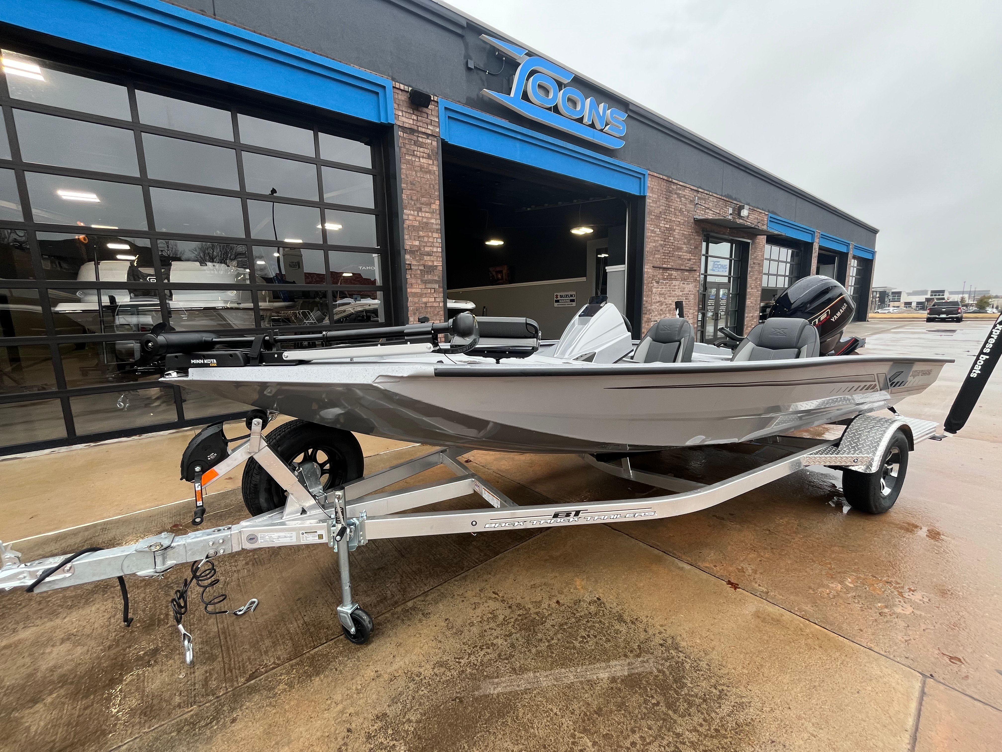 2026 Xpress H18C Crappie boat parked outside a store.