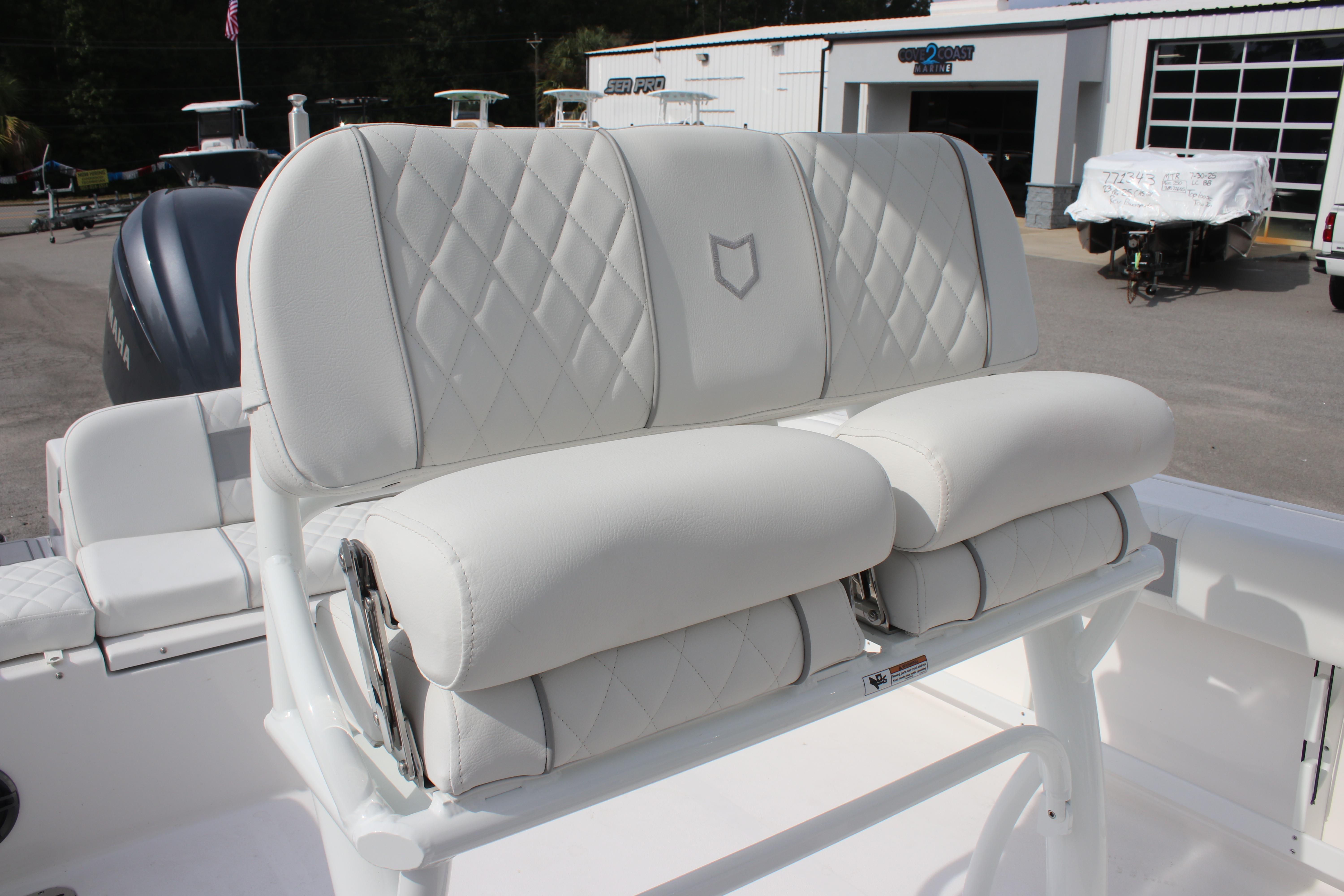 2026 Sea Fox 248 Commander boat with white cushioned seating and diamond stitching.