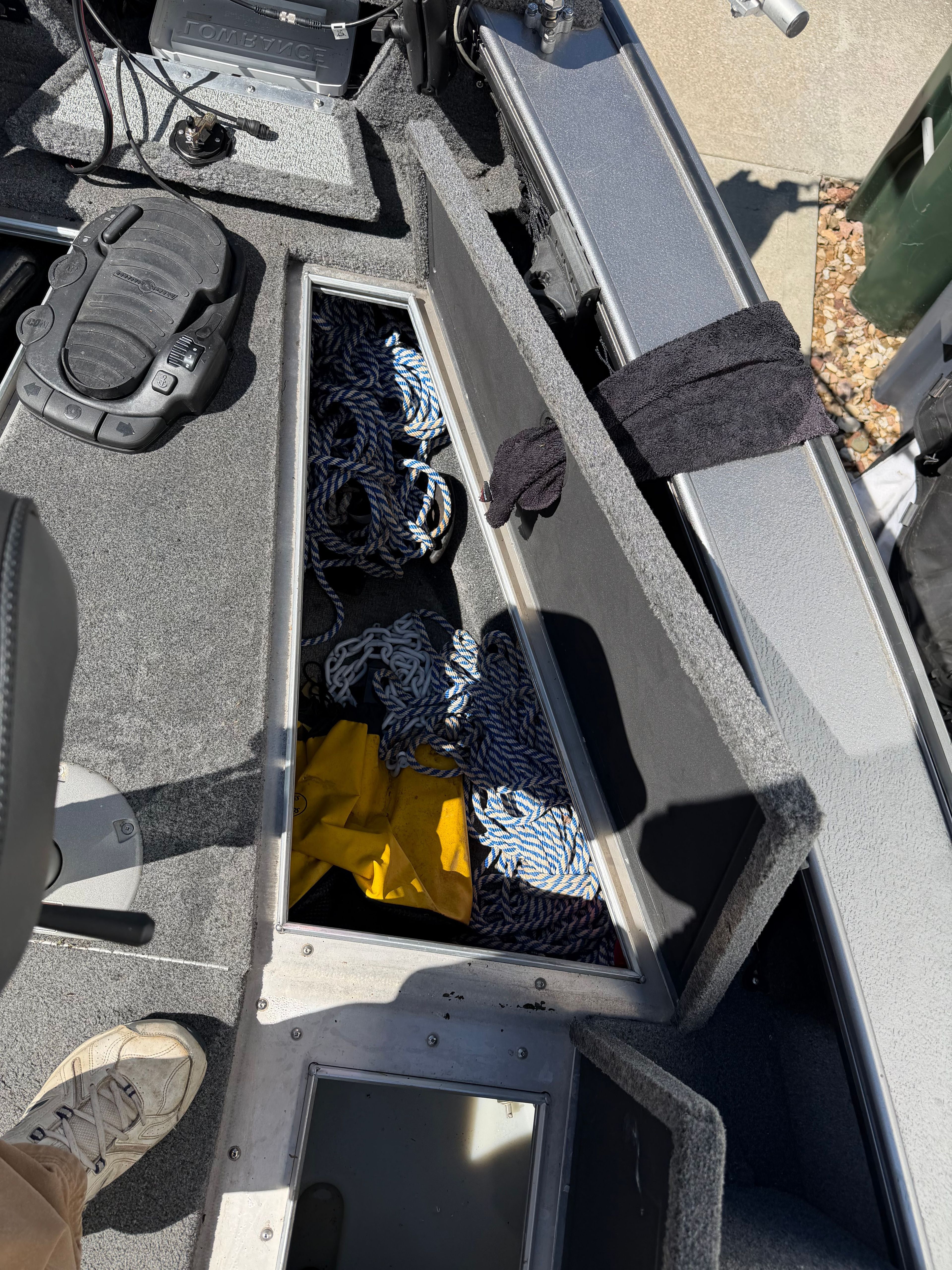 Interior of a 2017 Lund Pro V 1975 boat with storage compartment.