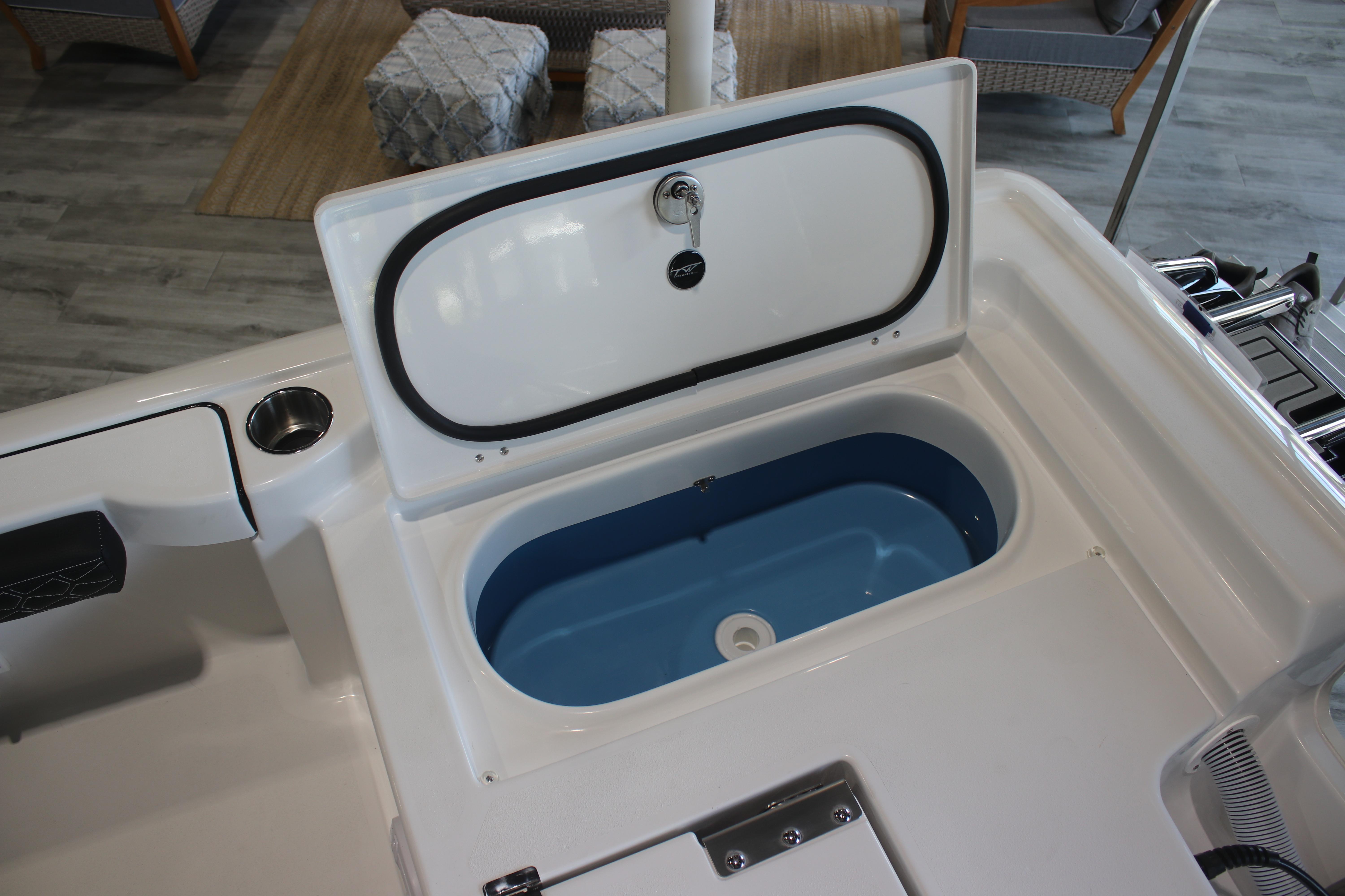 2026 Tidewater 2300 Carolina Bay boat with open storage compartment, showcasing interior design.