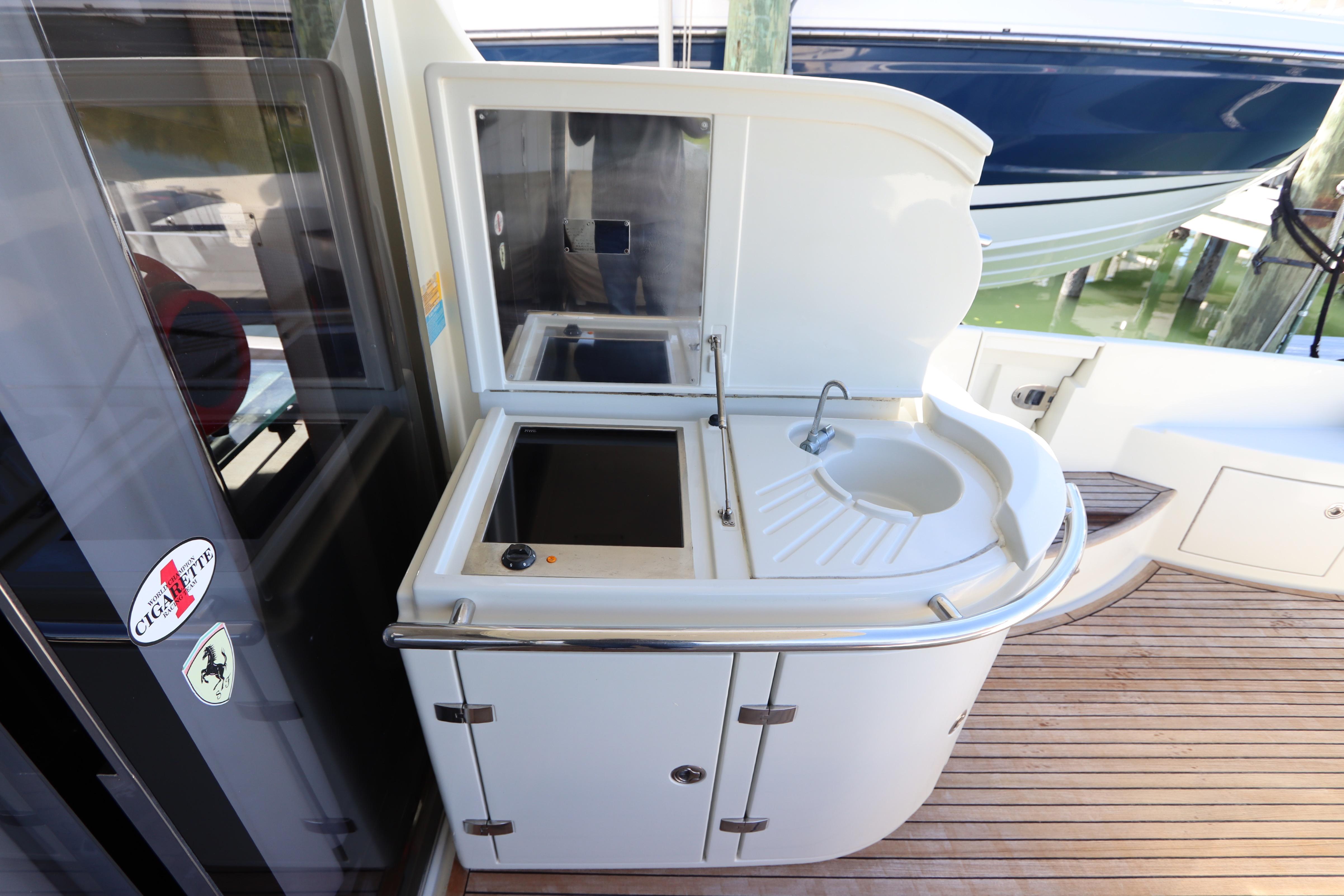 Outdoor kitchenette on 2007 Azimut 62S yacht with sink and storage.