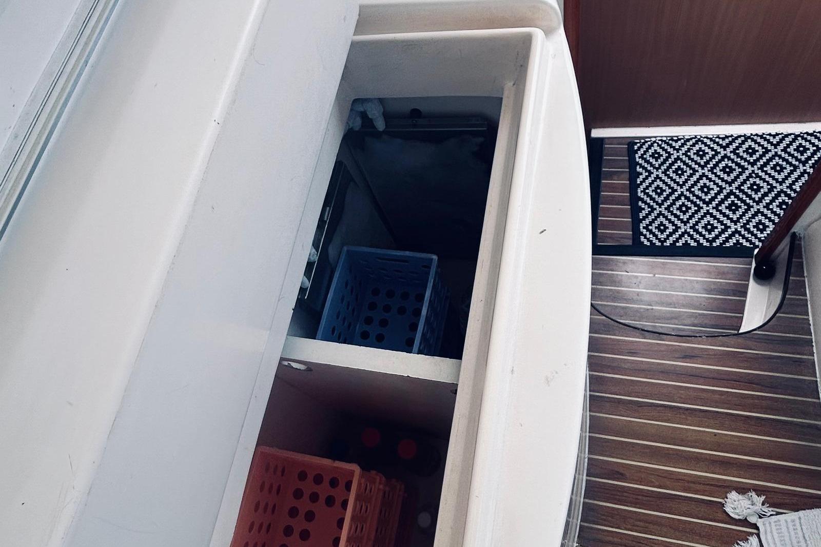 Interior view of a 2001 Robertson & Caine Leopard yacht with storage compartments.