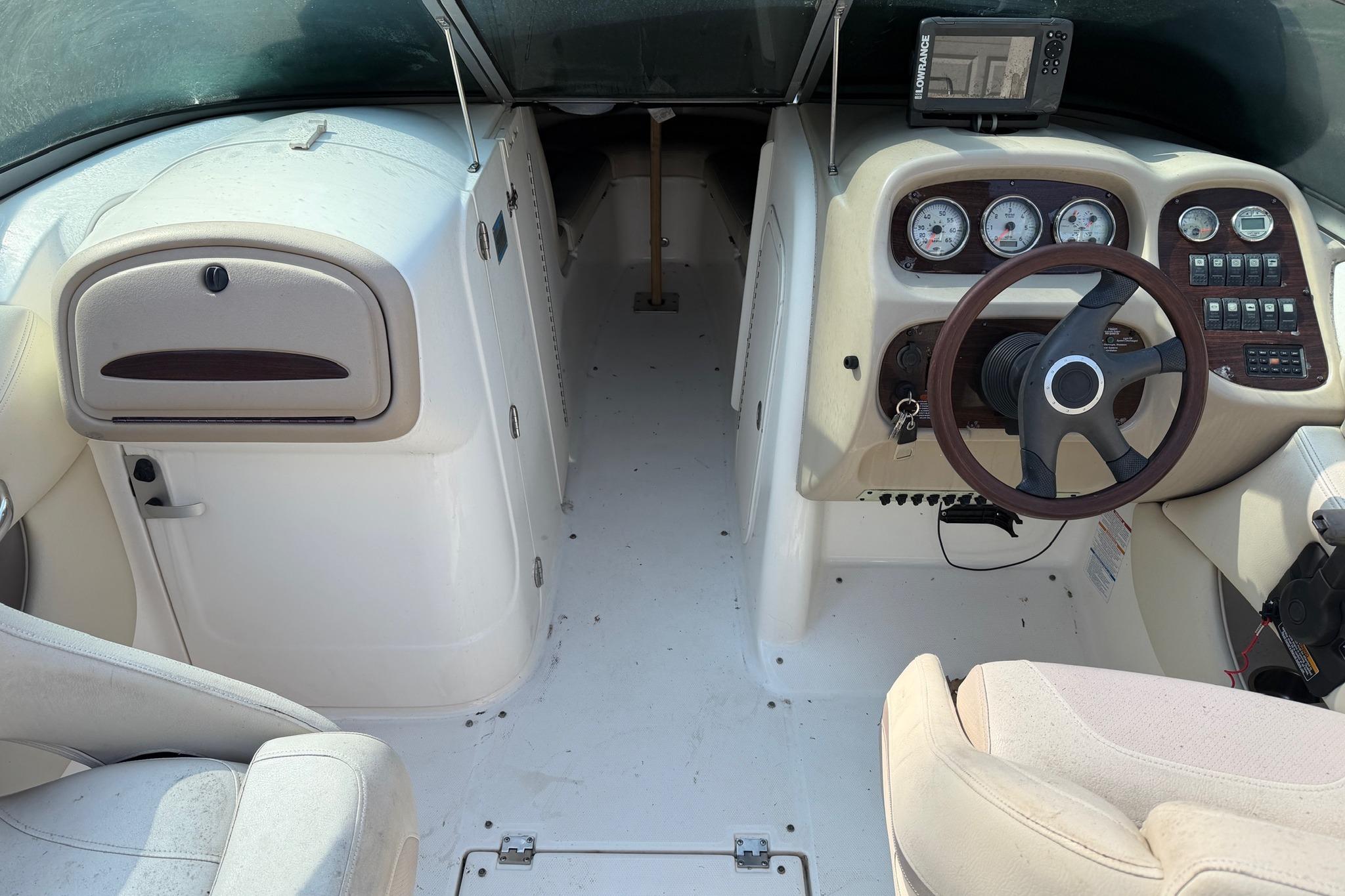 2005 Chaparral 256 SSi boat interior with steering wheel, gauges, and navigation system.