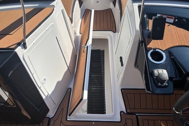 2026 Yamaha Boats 222SE interior with open storage compartment and modern controls.