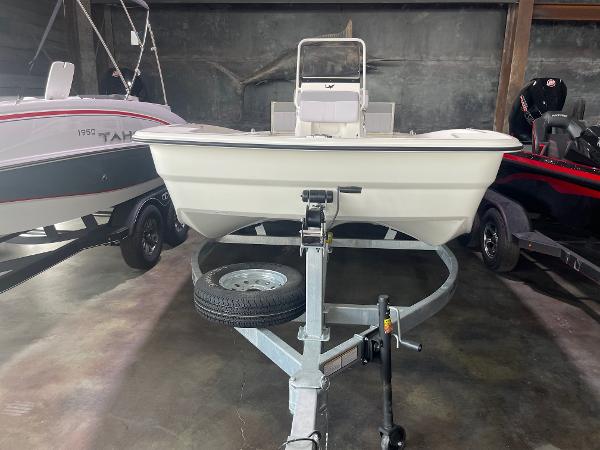 2024 Mako Pro Skiff 19 CC boat on trailer in showroom.