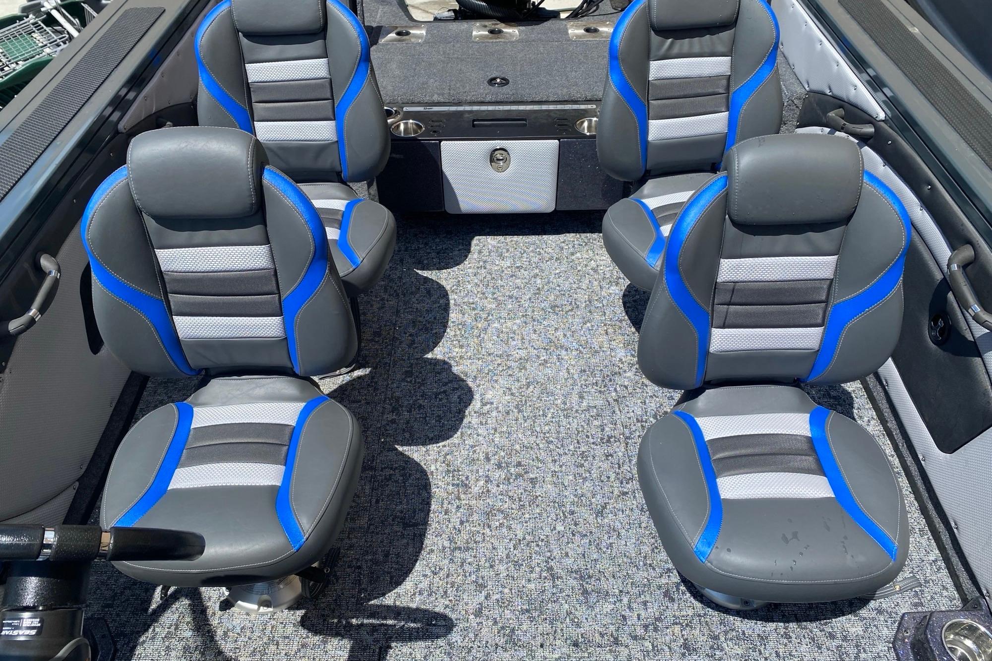 2026 Ranger VX1888 WT boat interior with four blue and gray seats on a carpeted floor.