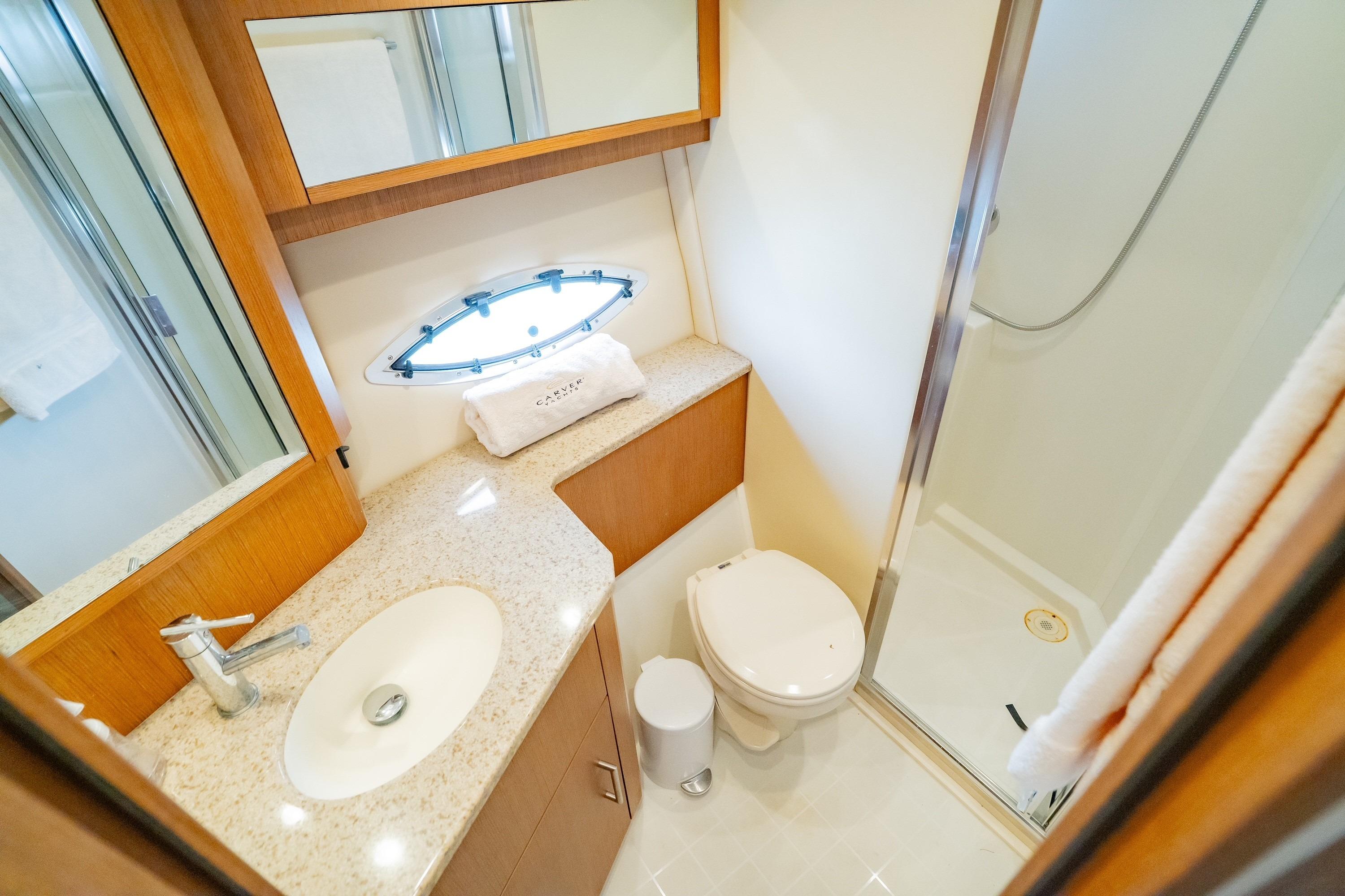 Luxurious bathroom in 2011 Carver 44 Sojourn yacht with modern fixtures and shower.