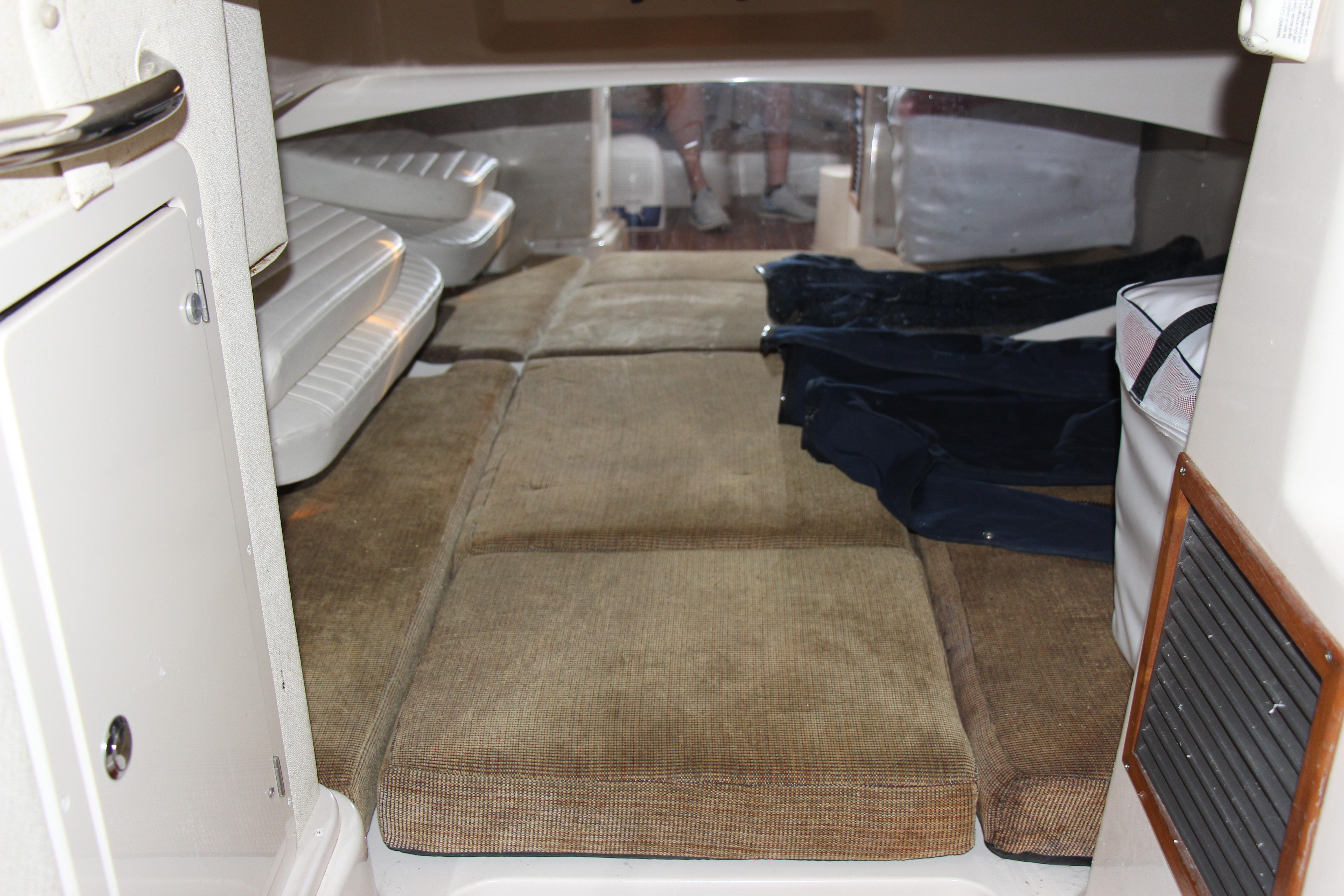 2005 Grady-White Express 330 cabin interior with cushioned seating and storage.