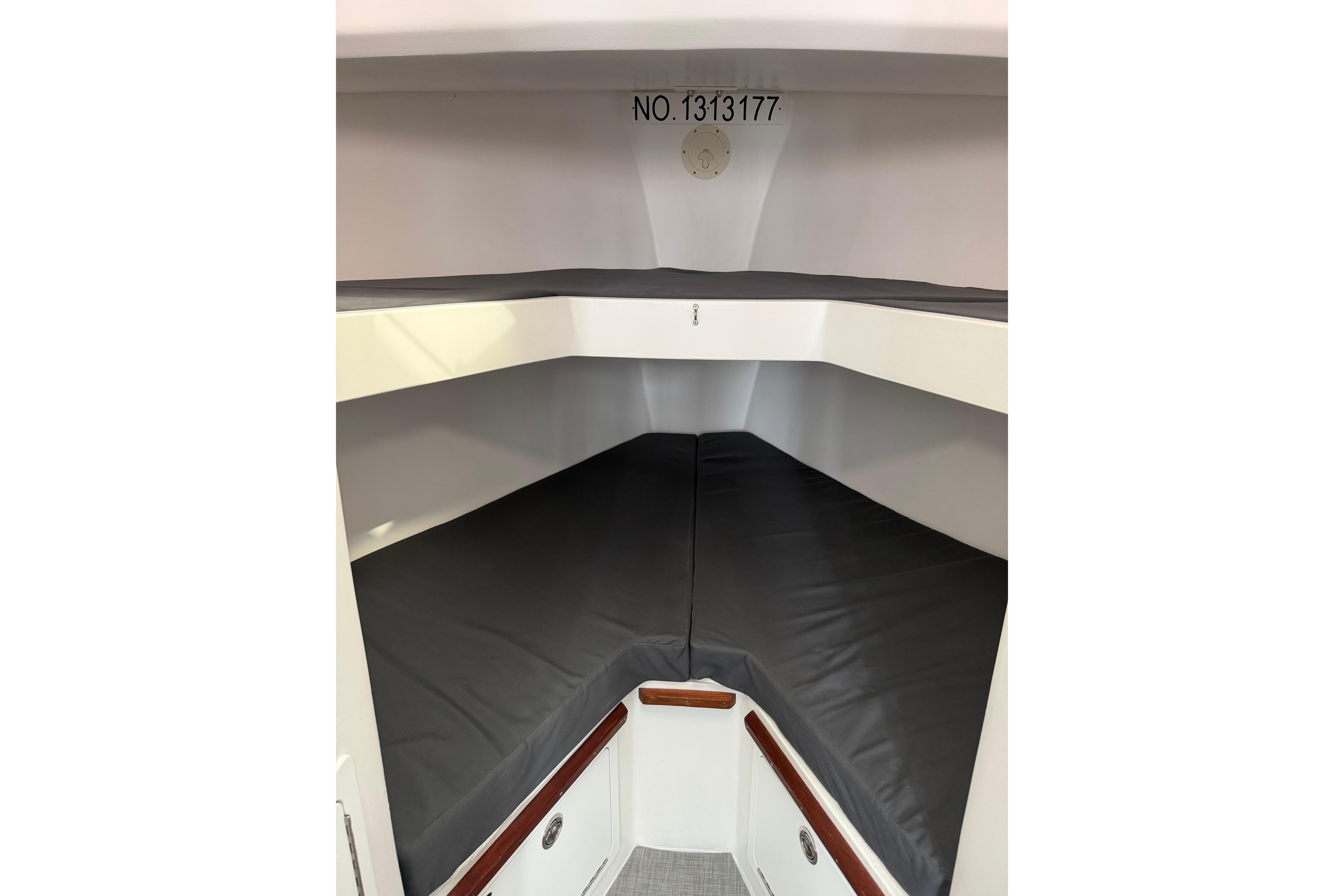 2018 H&H Marine Osmond Beal cabin interior with gray cushions and storage compartments.
