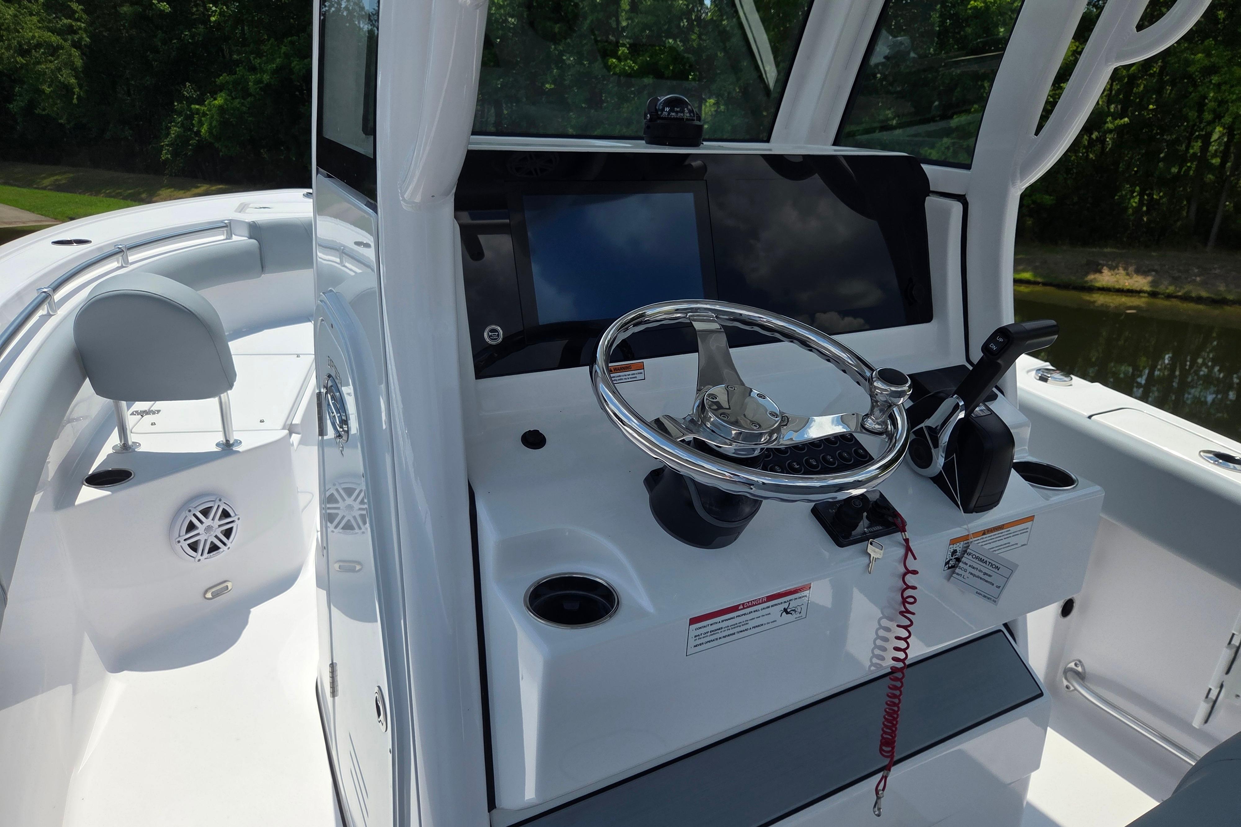 2026 Sportsman Open 212 Center Console boat interior with steering wheel and controls.