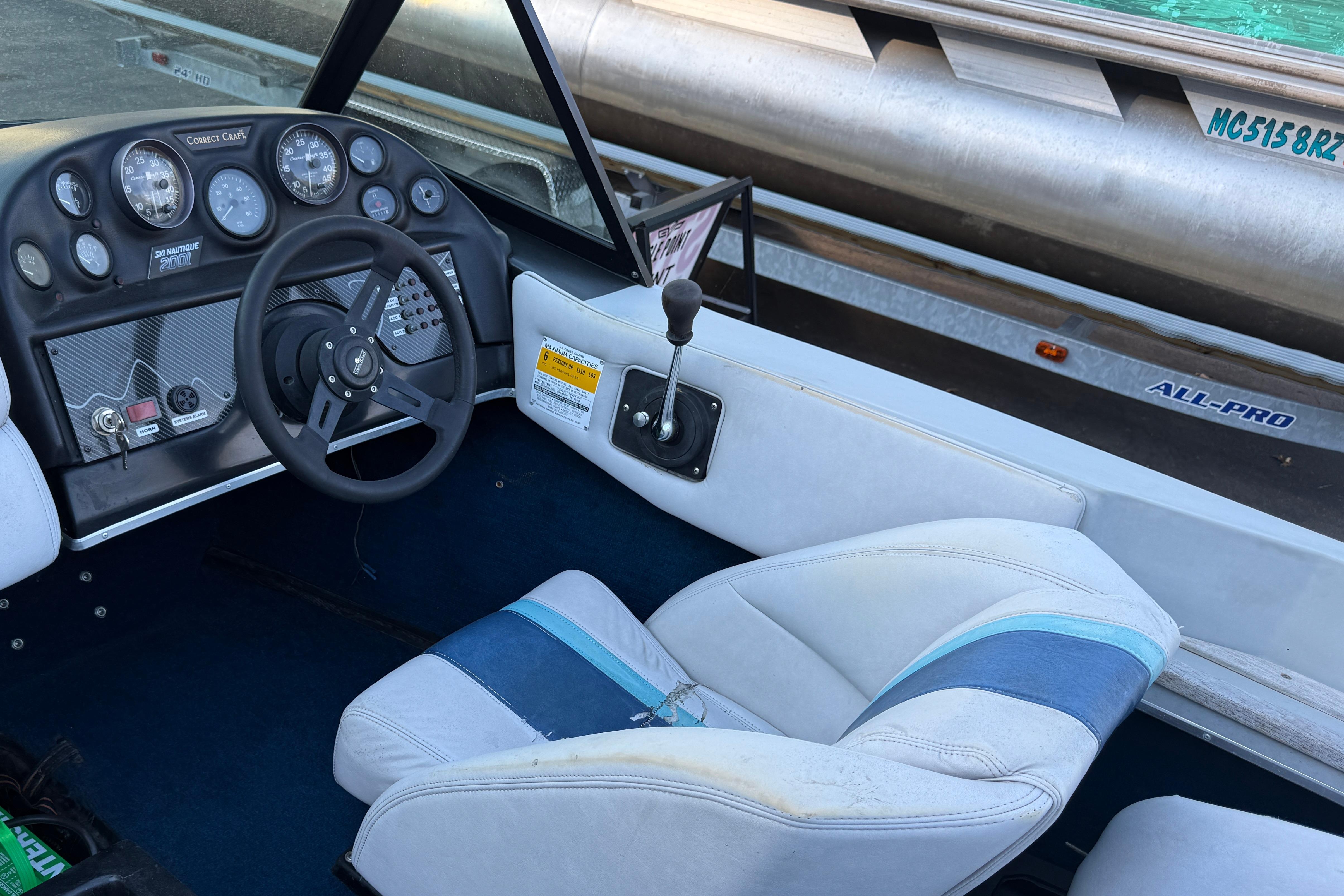 1989 Correct Craft Ski Nautique boat interior with steering wheel and dashboard controls.