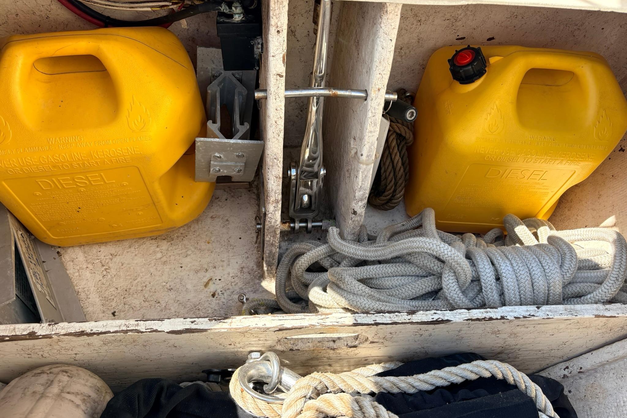 Yellow diesel containers and ropes in a 2009 Caliber 40LRC SE boat storage compartment.