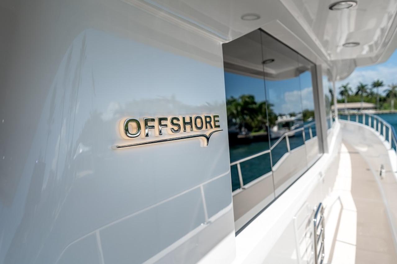 2027 Offshore Yachts 70 CE, sleek design with reflective windows and elegant branding.