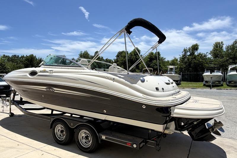 2007 Sea Ray 240 Sundeck boat on trailer under clear blue sky.