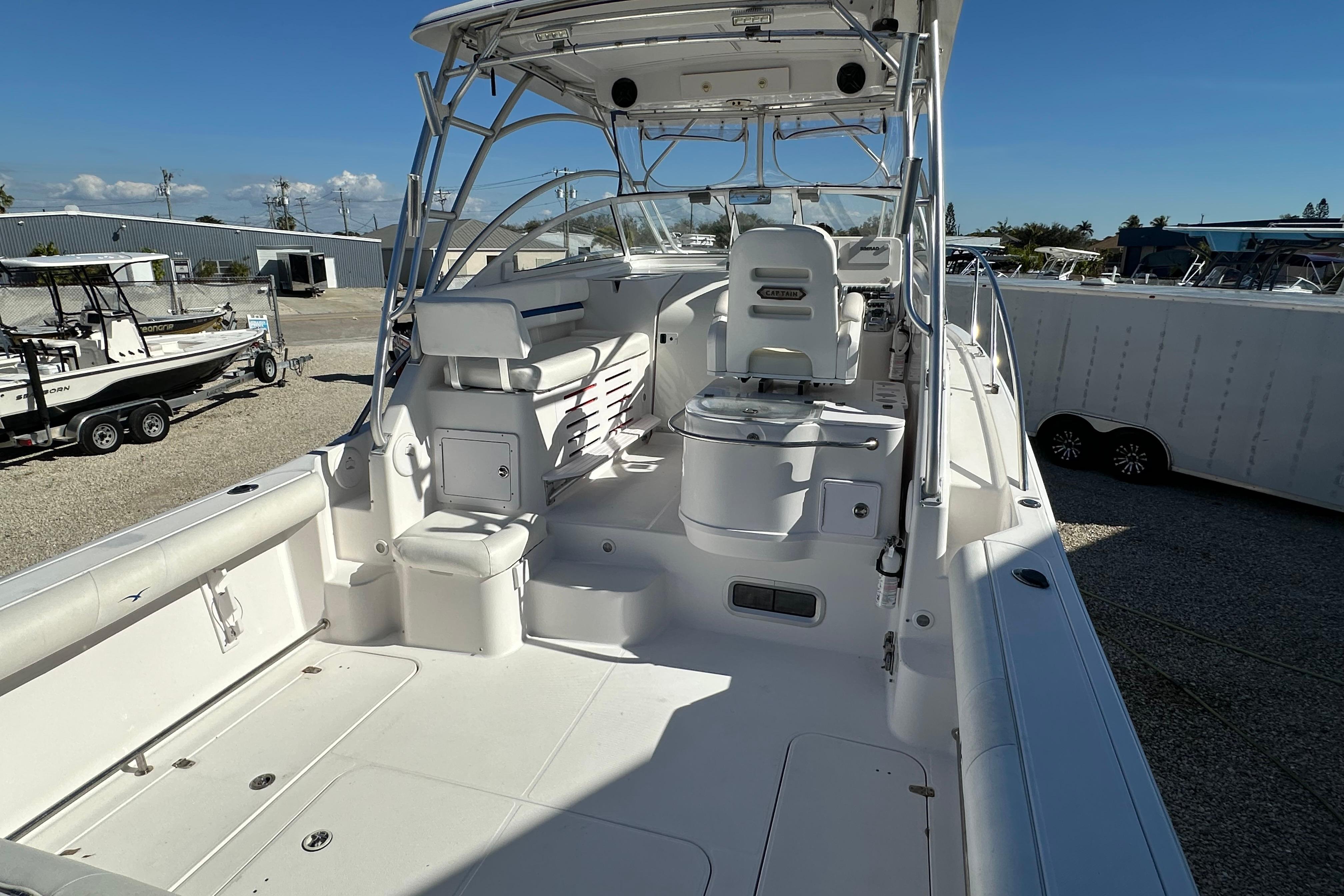 2006 Pro-Line 32 Express boat interior with seating and helm, docked outdoors.