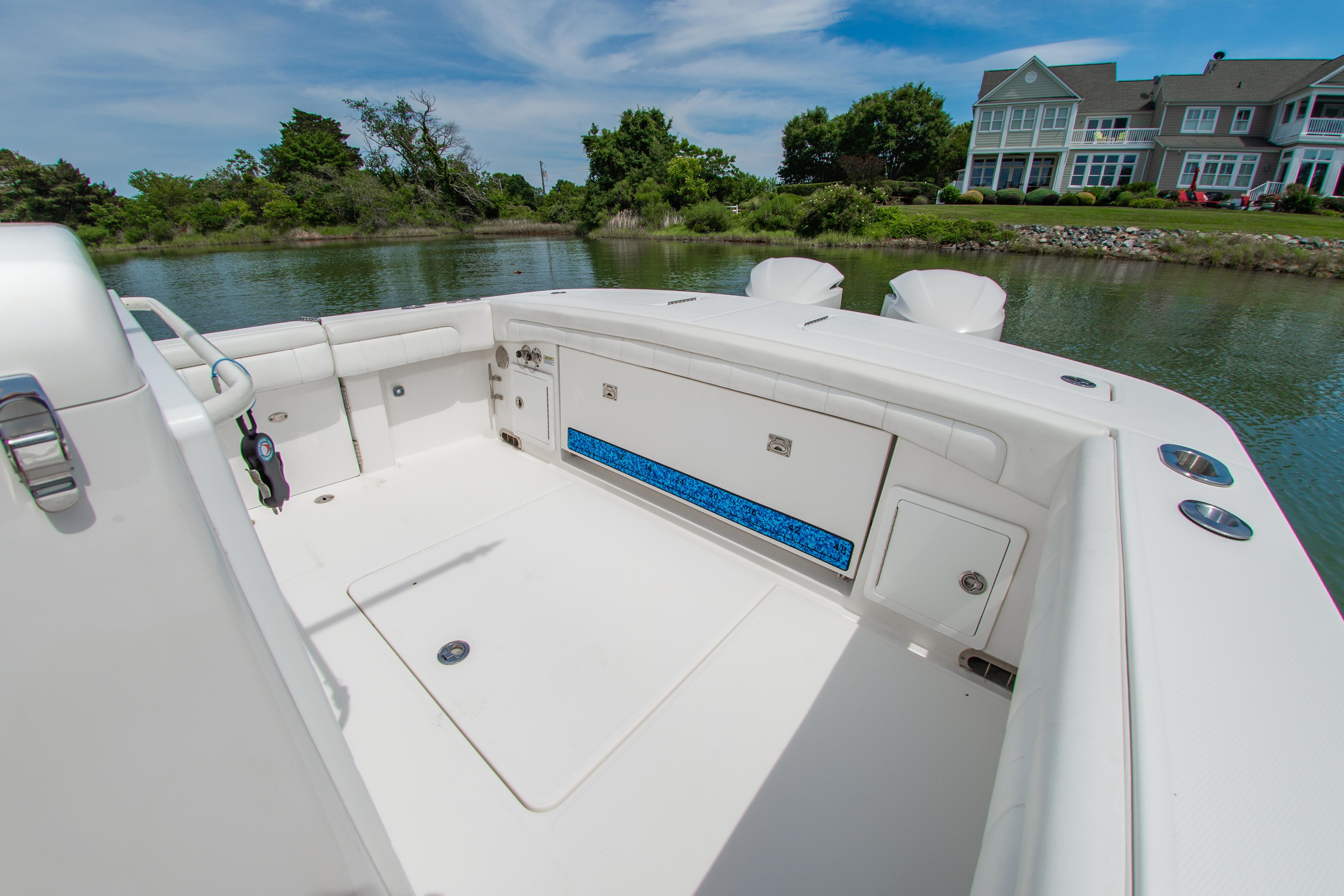 2019 Regulator 31 boat interior with seating, storage, and scenic waterfront view.