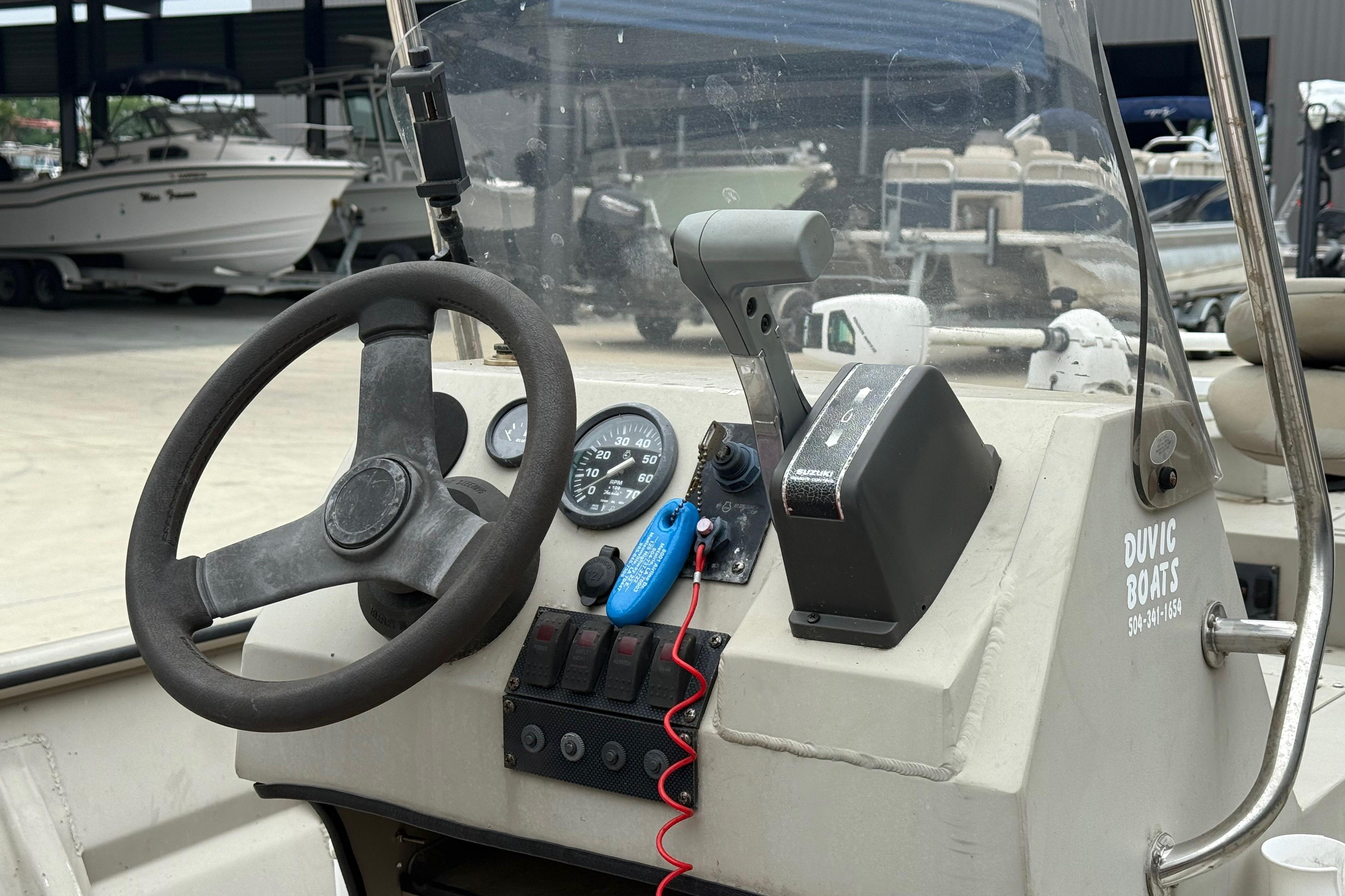 2008 SeaArk 1652 MV boat dashboard with steering wheel and controls.