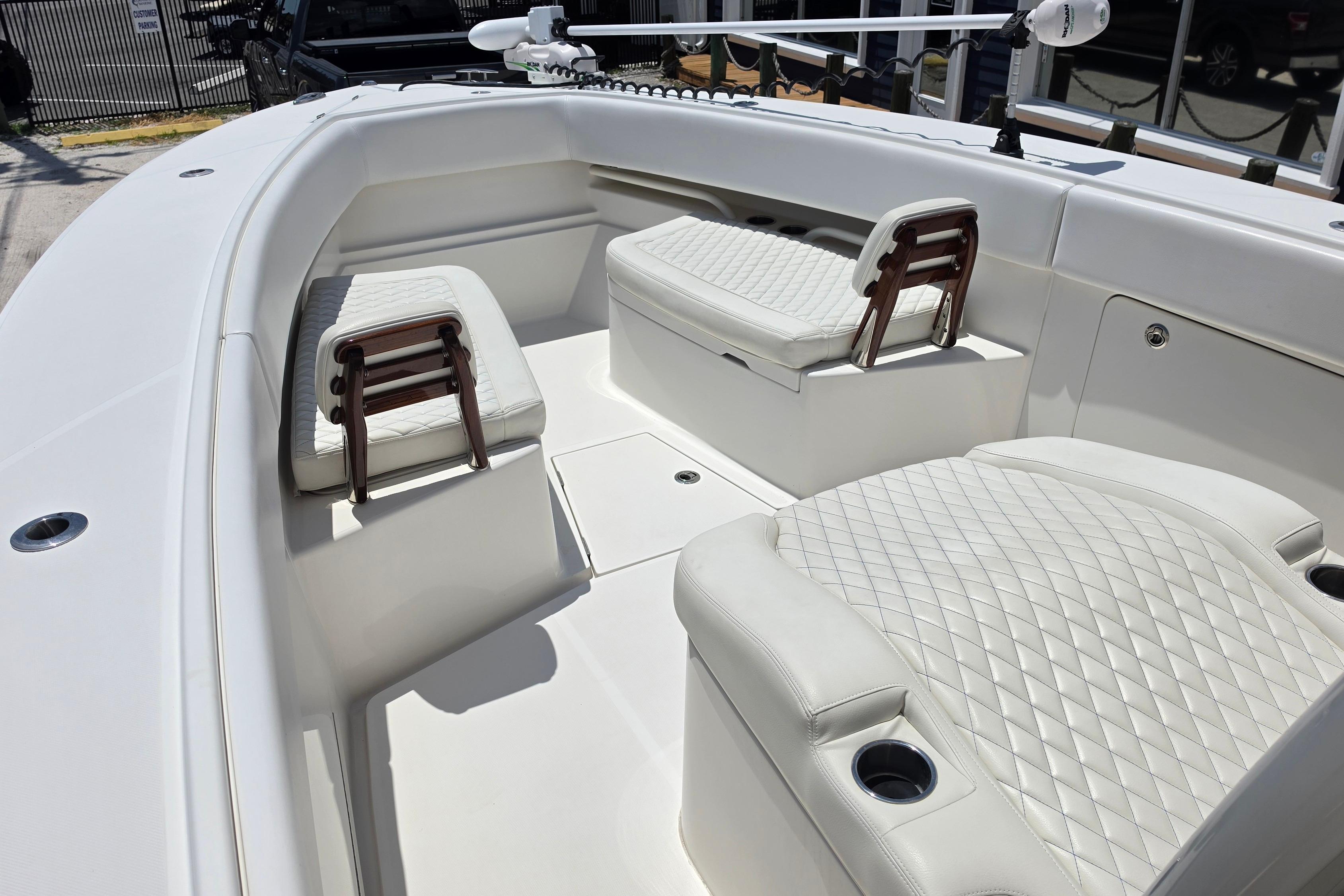 2020 Jupiter 34 HFS boat interior with white quilted seating and cup holders.