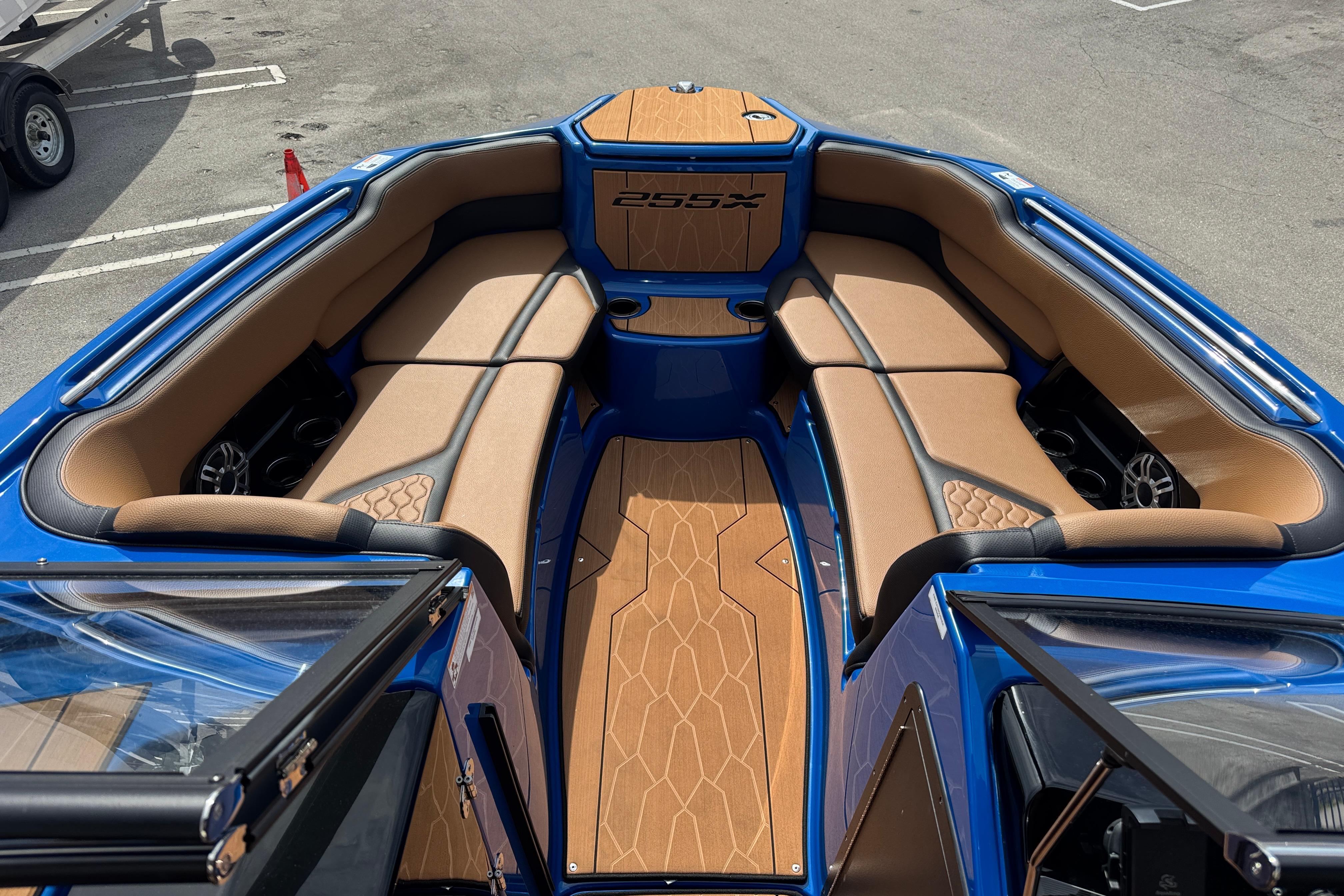 2026 Yamaha Boats 255XD interior with tan seating and blue accents, showcasing luxury design.