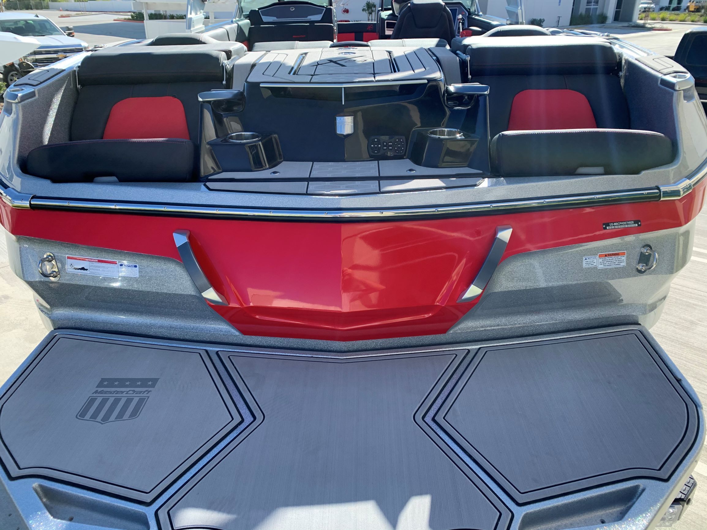 The image shows the stern of a 2020 MasterCraft X24 boat with red accents.