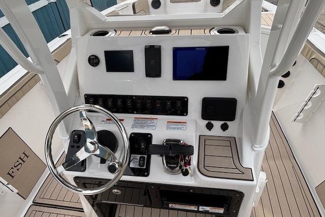 2026 Yamaha Boats 222 FSH Sport E dashboard with steering wheel and control panel.
