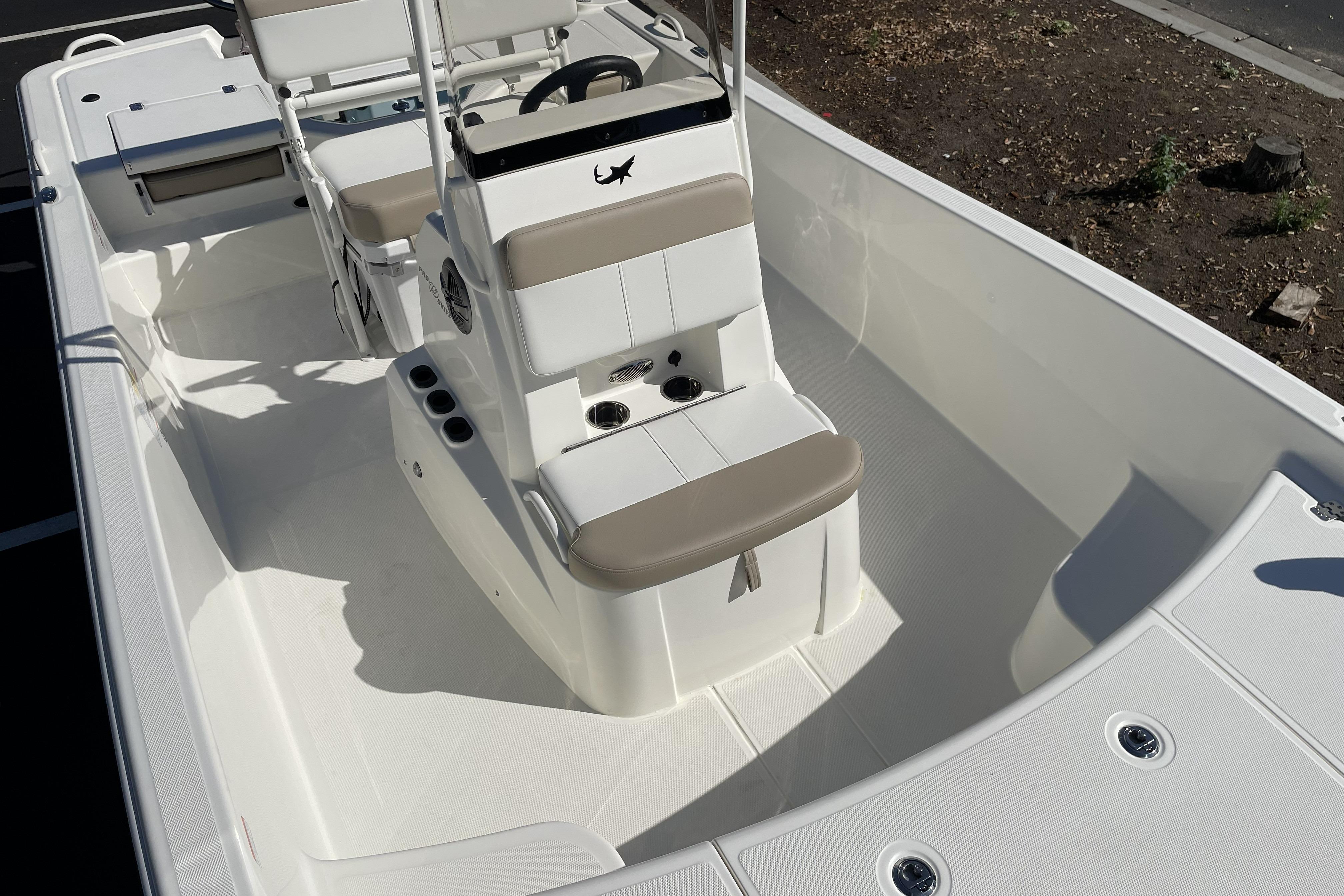 2026 Mako Pro Skiff 19 CC boat interior with seating and steering console.