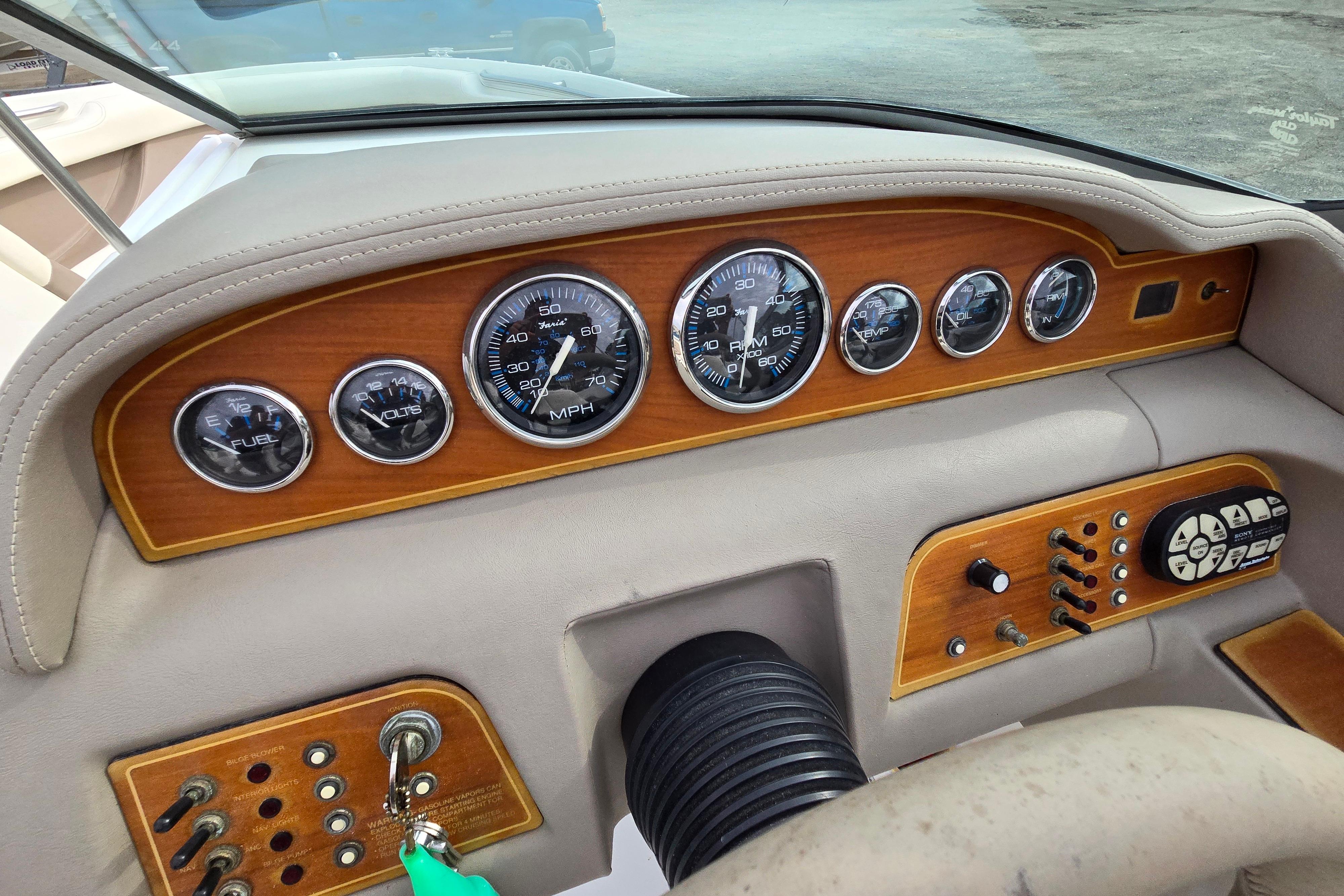 Dashboard of a 2000 Cobalt 246 boat with wood paneling and gauges.