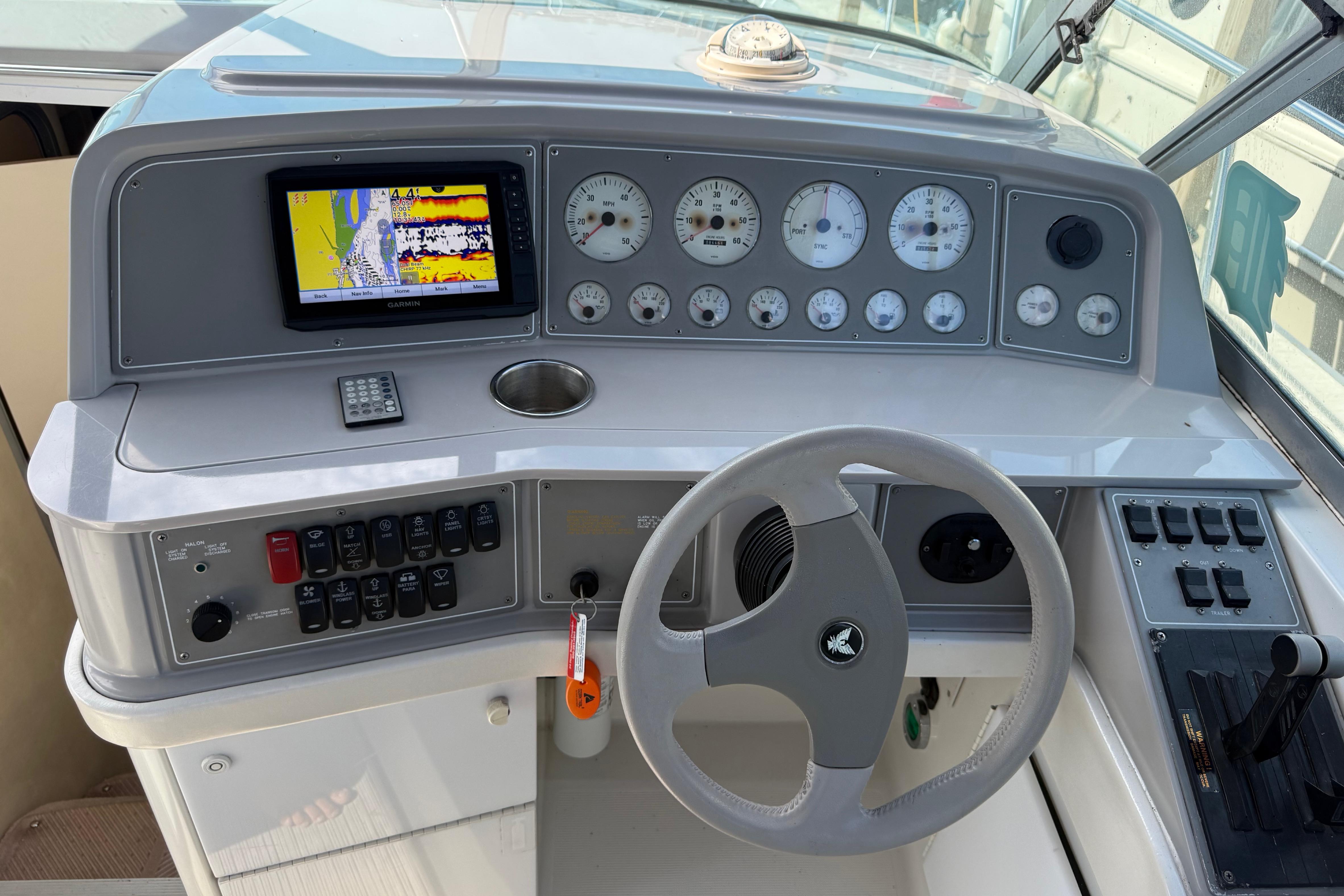 1999 Formula 34 Performance Cruiser dashboard with steering wheel and navigation instruments.