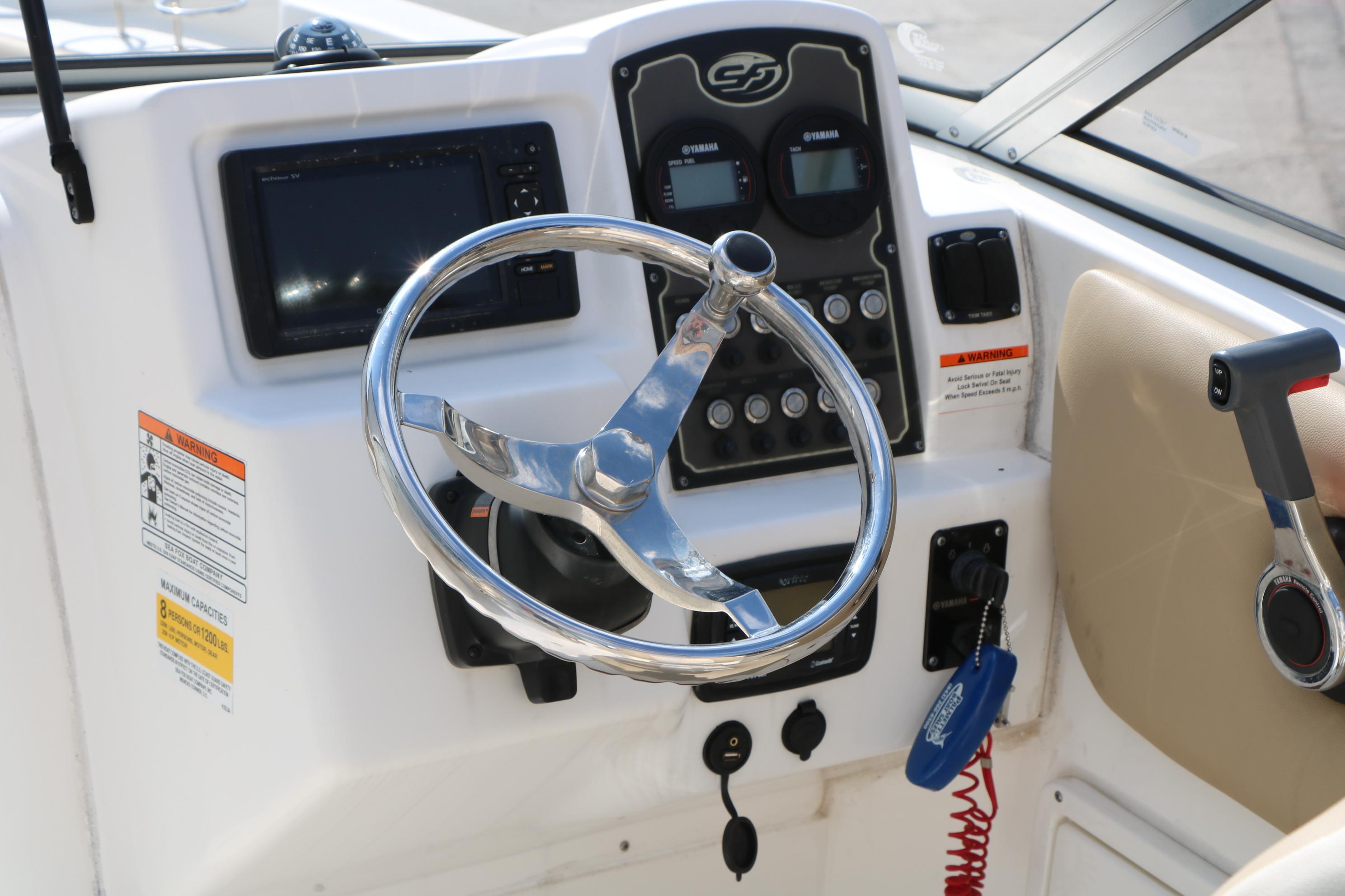 Steering console of a 2017 Sea Fox 226 Traveler boat with controls and gauges.
