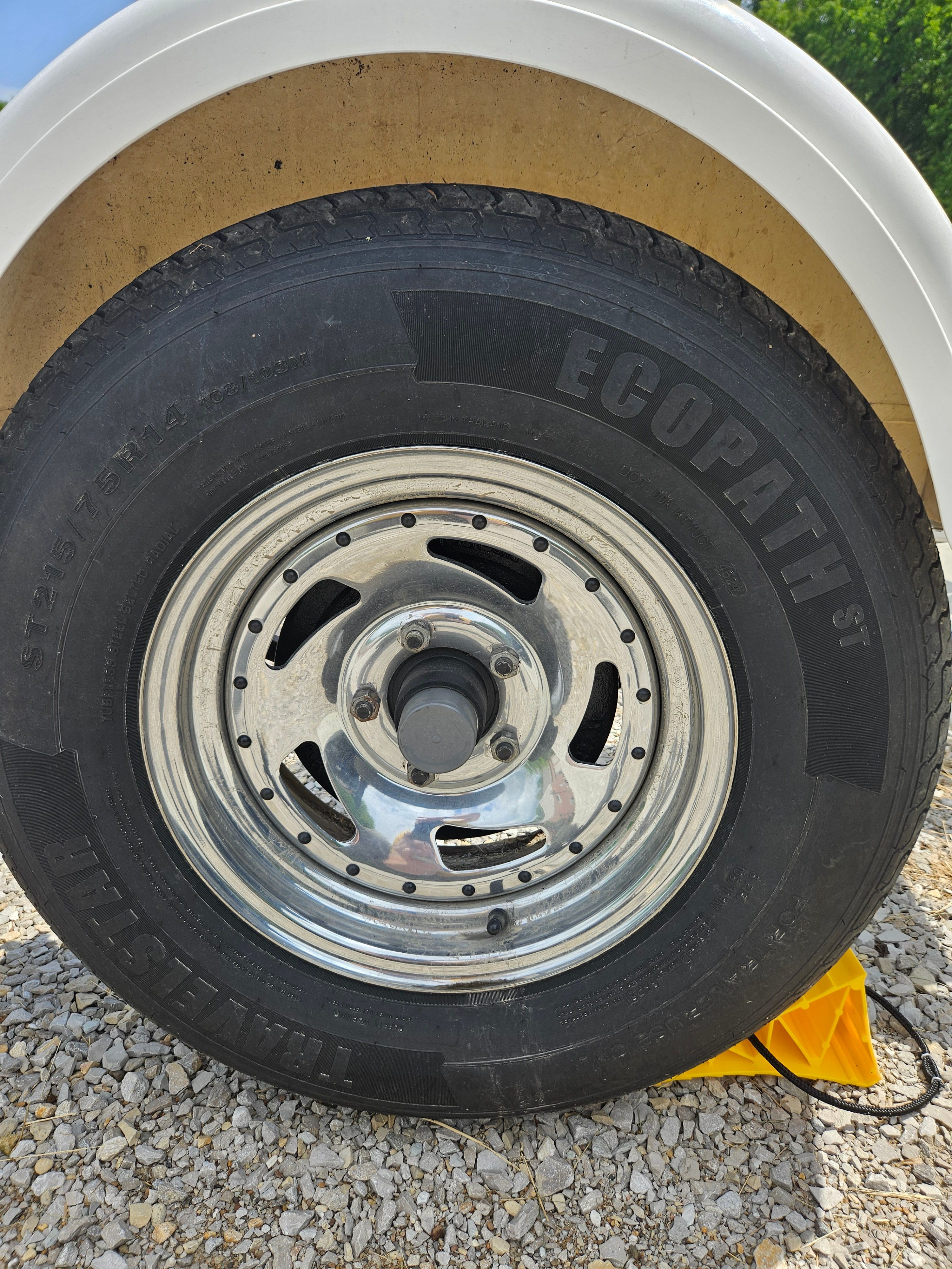 Close-up of a Yacht Club R2466TB tire on gravel.