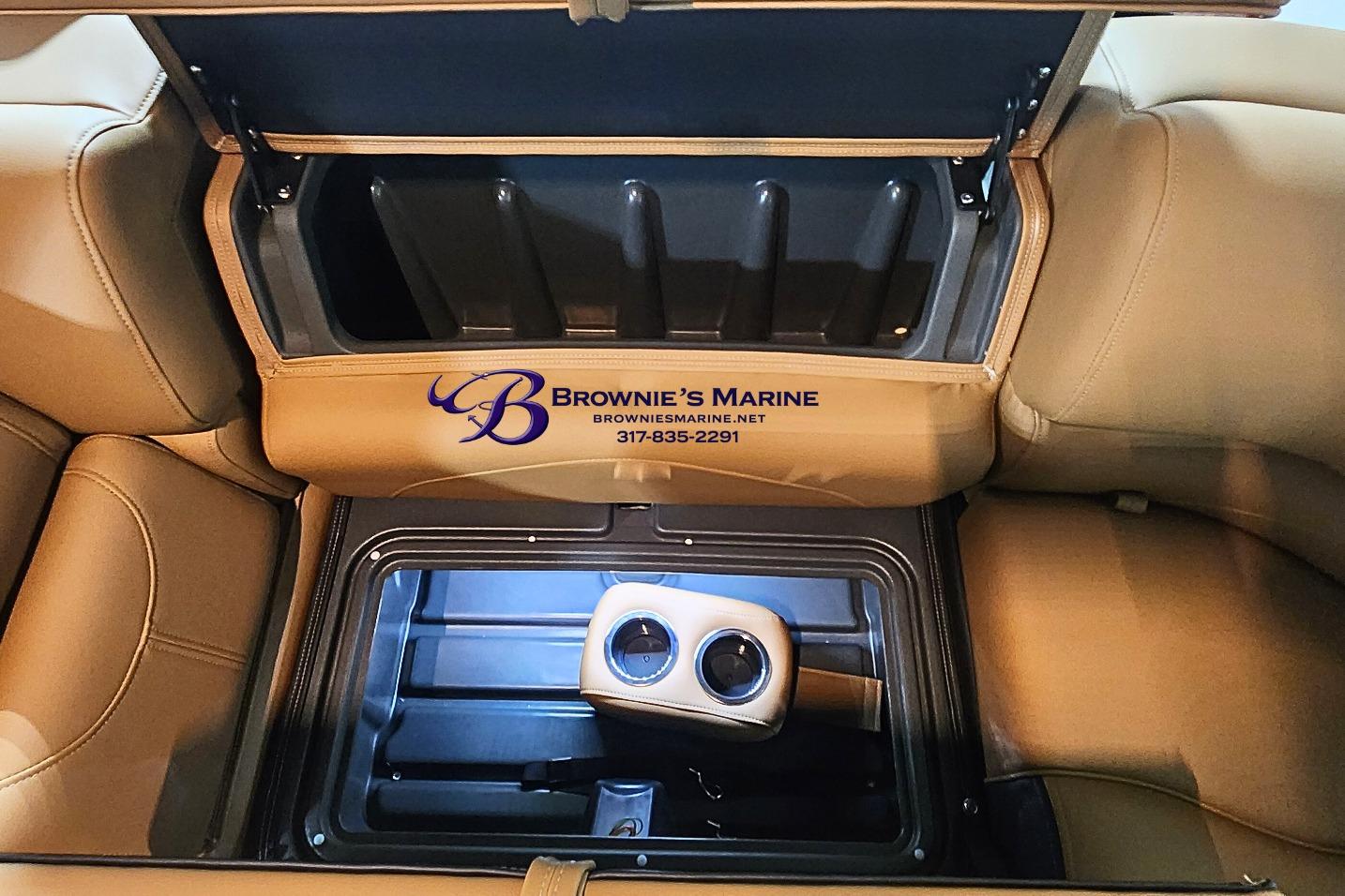 Open storage compartment in 2026 Regency 250 DL boat with cup holders.