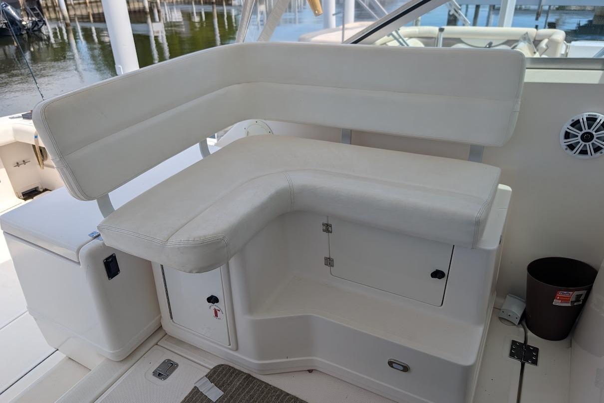 2000 Pursuit 3400 Express boat interior with white cushioned seating and storage compartments.