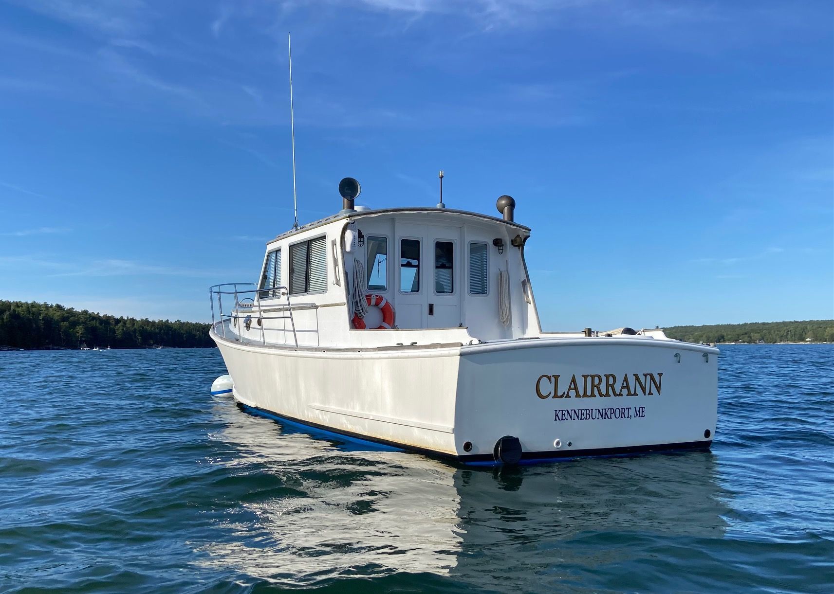 1985 Jarvis Newman Custom boat "CLAIRRANN" on water, Kennebunkport, ME, under clear blue sky.