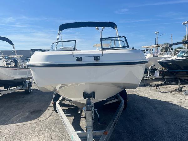 2021 Bayliner DX 2200 boat on trailer under clear blue sky.