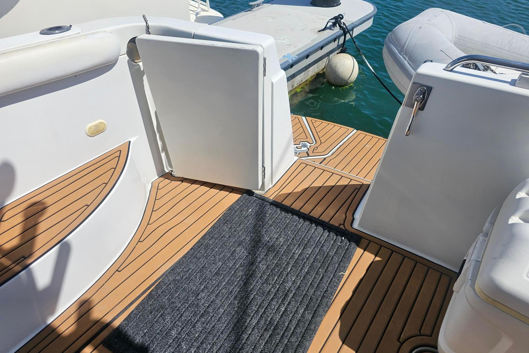 2002 Carver 450 Voyager Pilothouse deck with teak flooring and dock access.