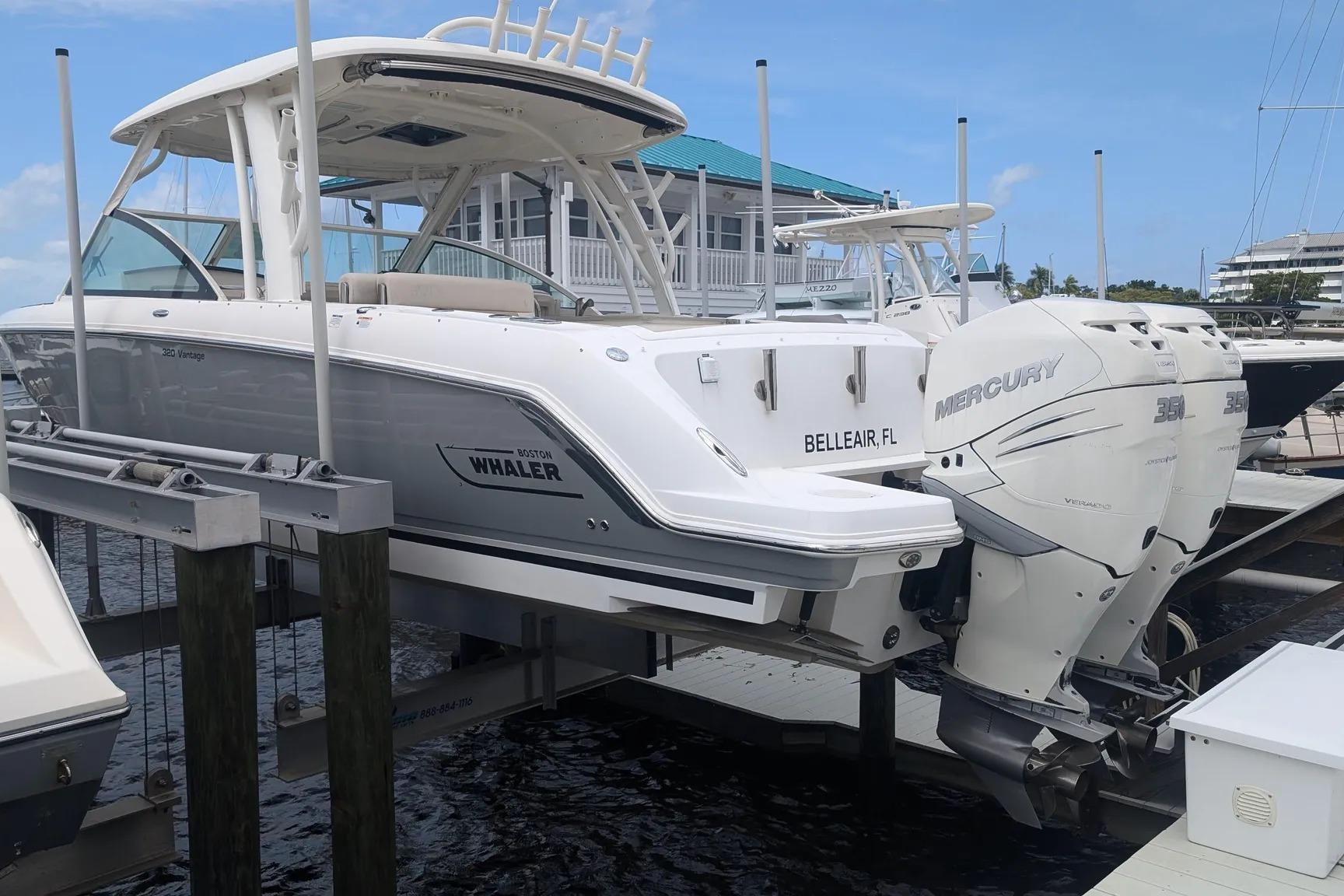 2017 Boston Whaler 320 Vantage boat docked with twin Mercury engines.