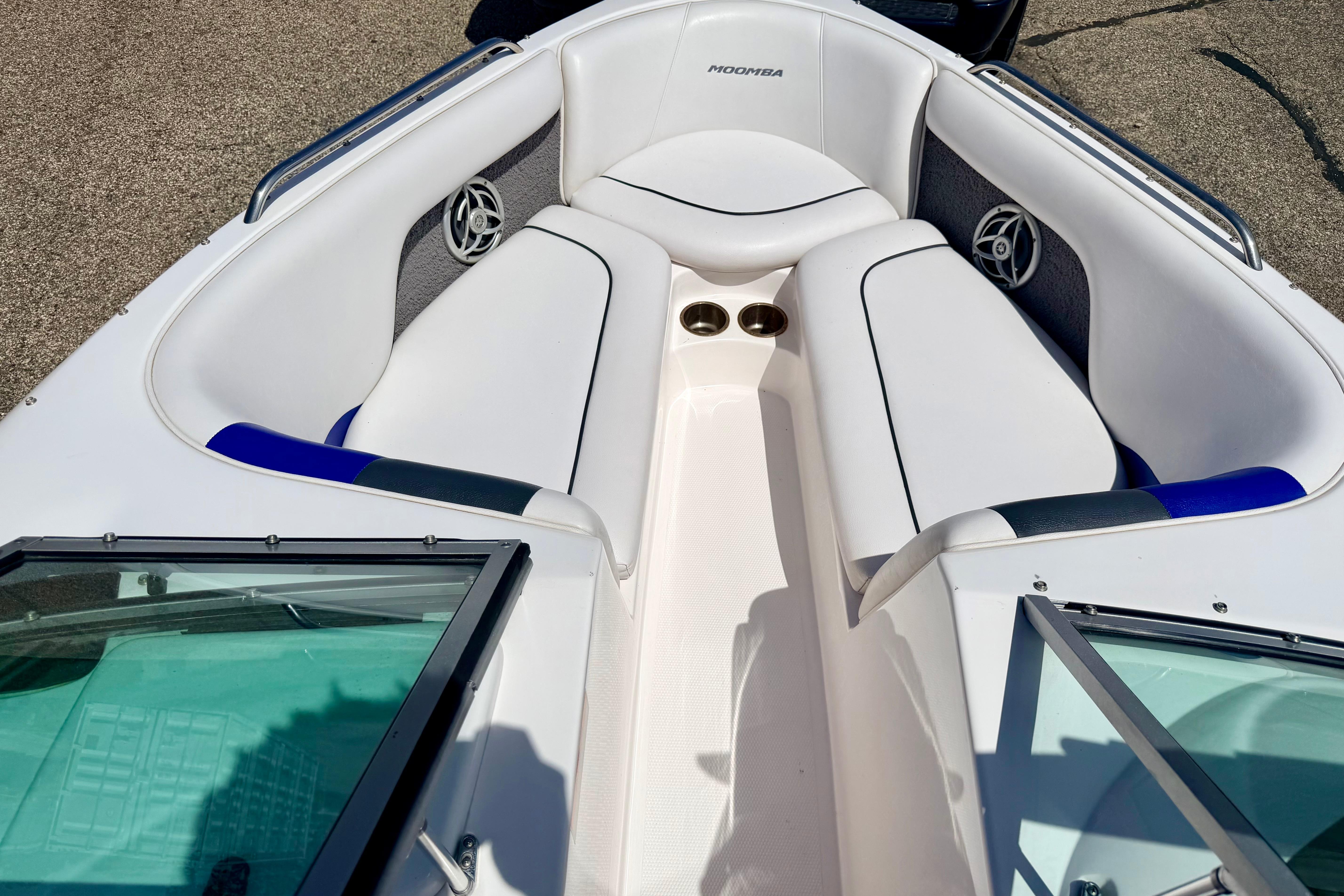 2008 Moomba Outback V boat interior with white seating and cup holders.