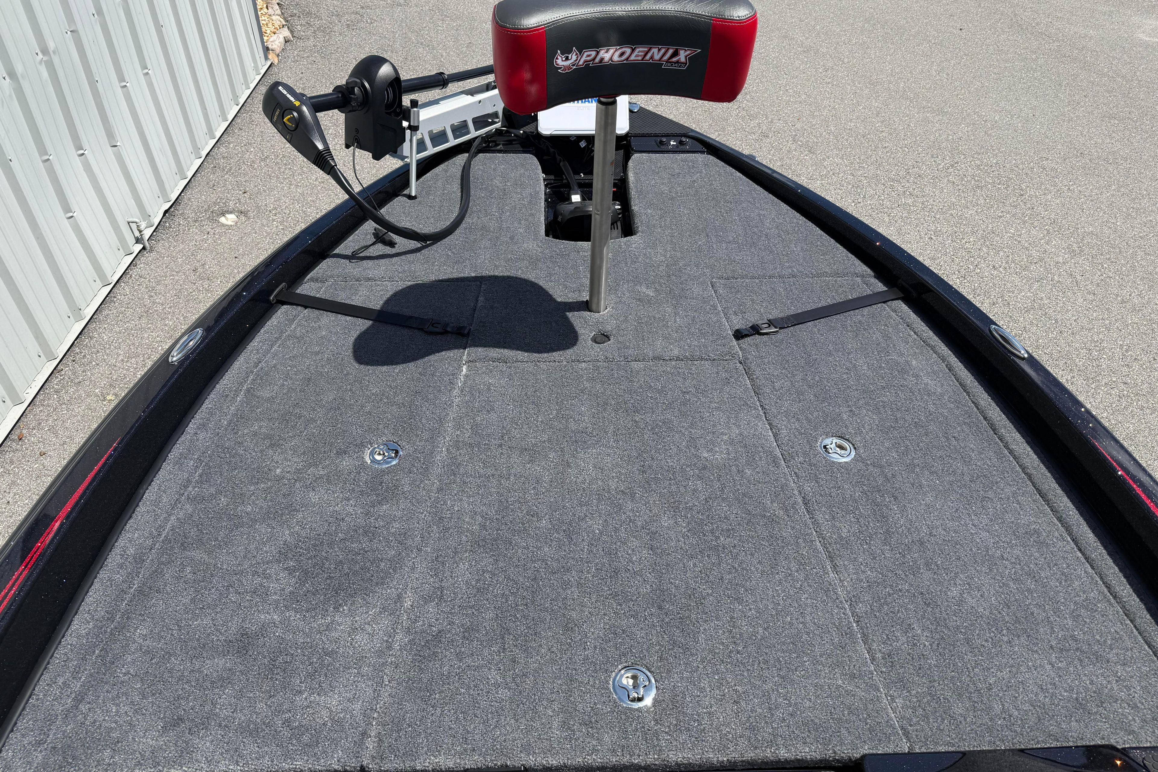 2027 Phoenix 919 ZXL boat deck with seating and control panel, featuring gray carpeting.