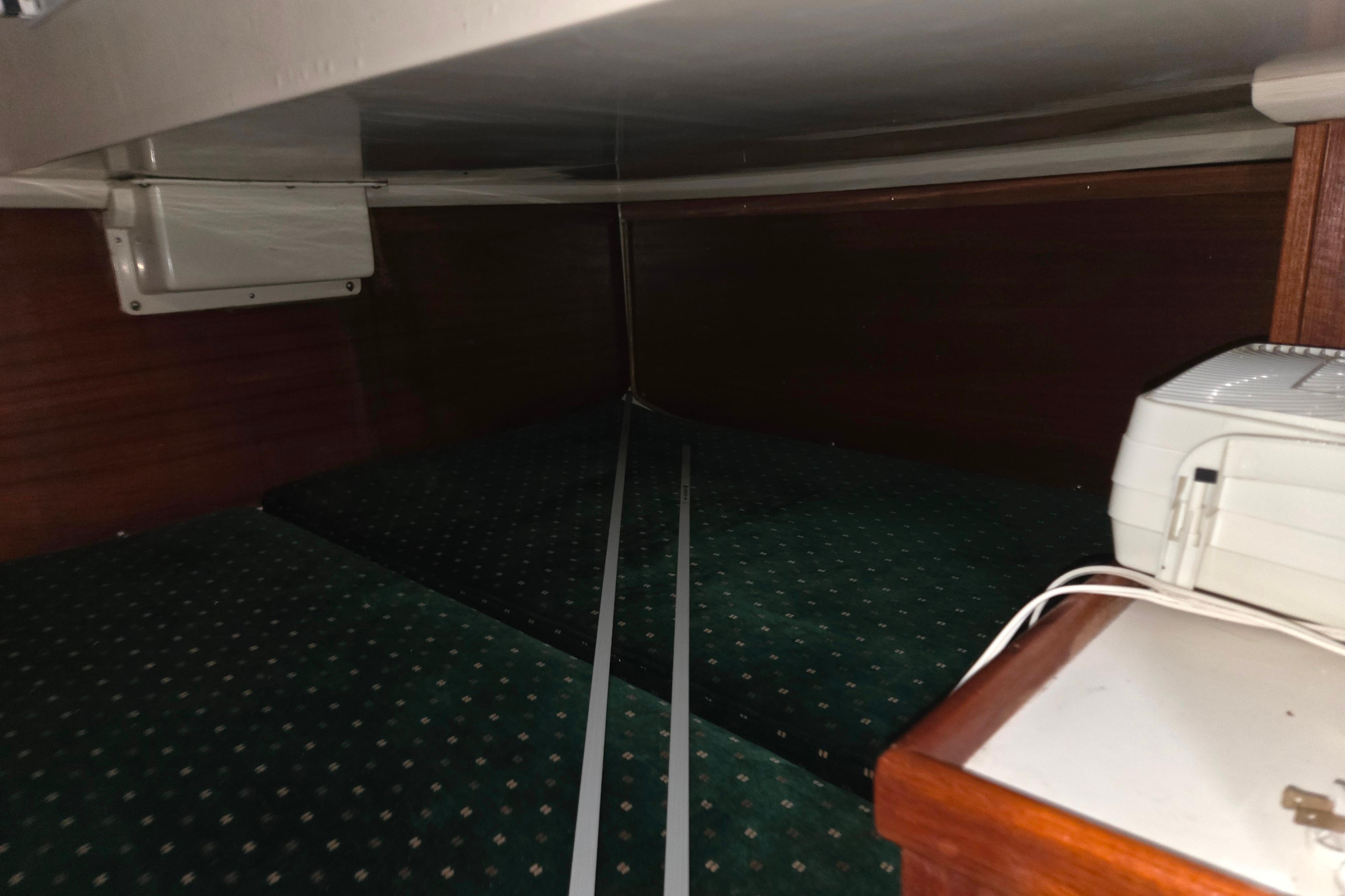 Interior cabin view of a 1986 Catalina 355 sailboat with green upholstery.