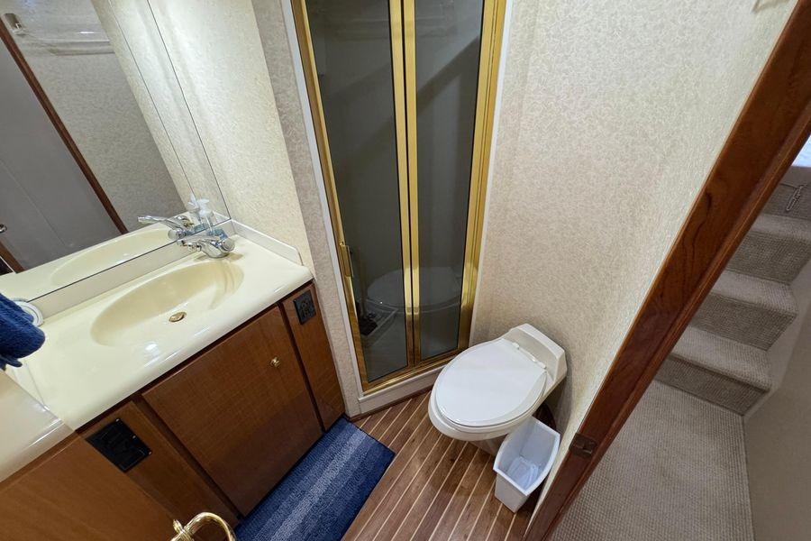 Bathroom interior of 2002 Viking 61 Enclosed Bridge yacht with shower and toilet.