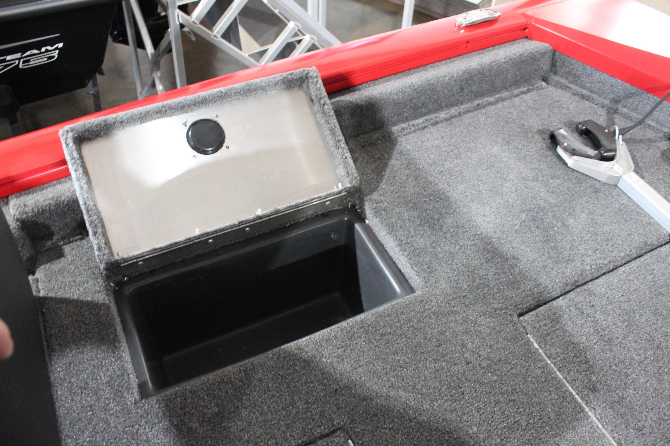 2026 Tracker Pro Team 175 boat storage compartment with open lid and carpeted interior.