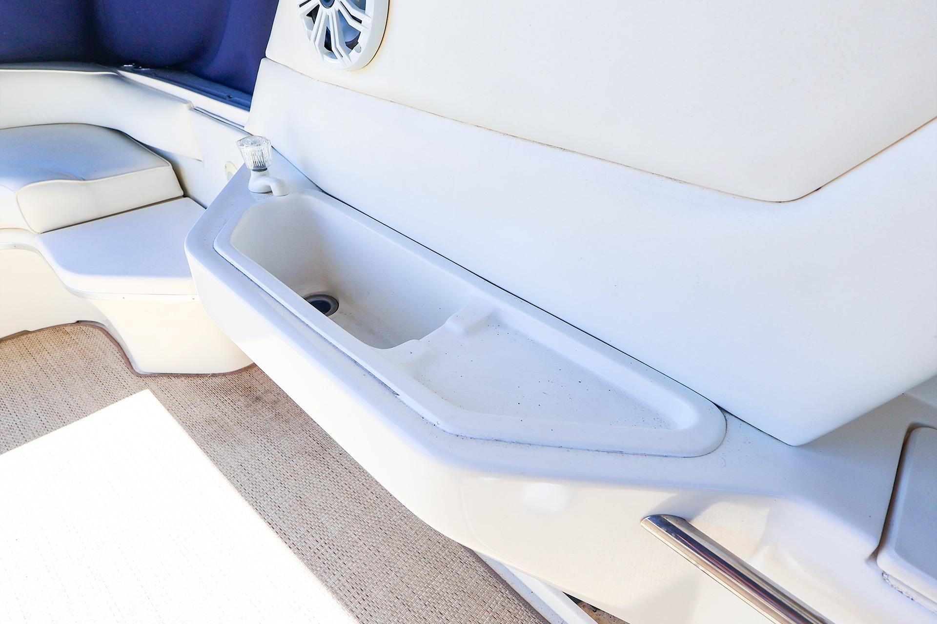 Interior view of a 1998 Sea Ray 500 Sundancer yacht featuring a built-in sink and seating area.