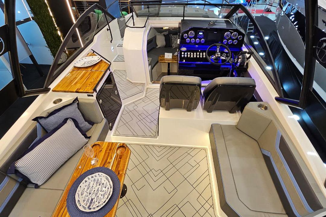 Luxurious interior of 2026 Hanover 327 boat with modern seating and elegant dining area.