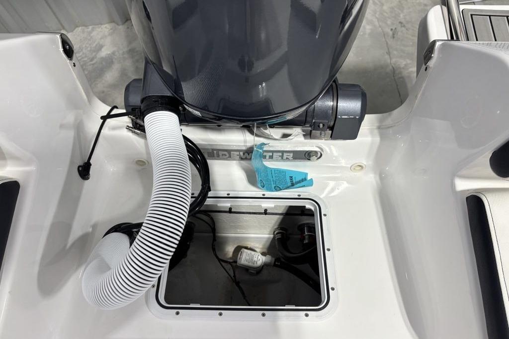 2026 Tidewater 198 CC Adventure boat engine compartment with visible hoses and components.