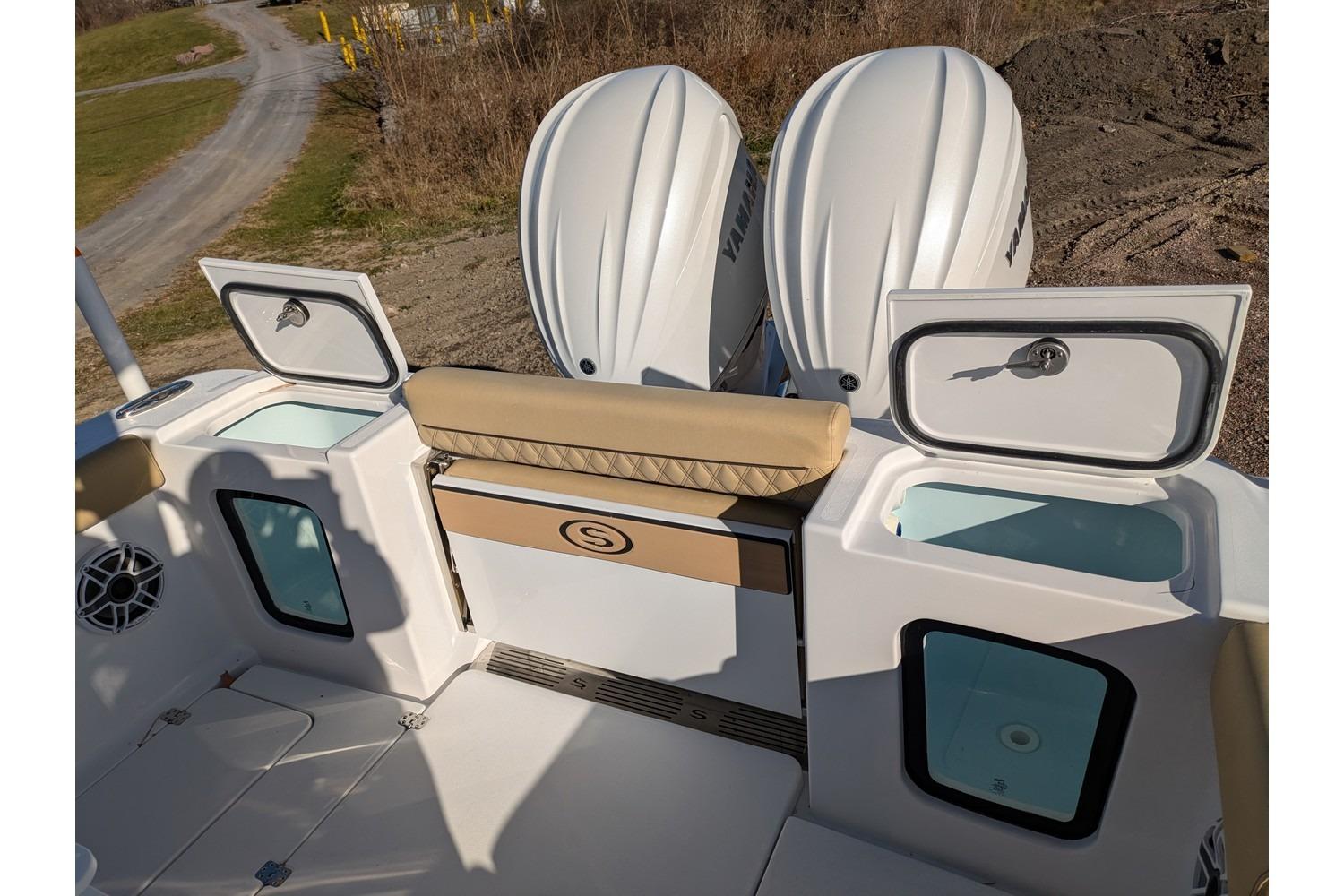 2025 Sportsman Open 282 Center Console boat with dual Yamaha engines and storage compartments.