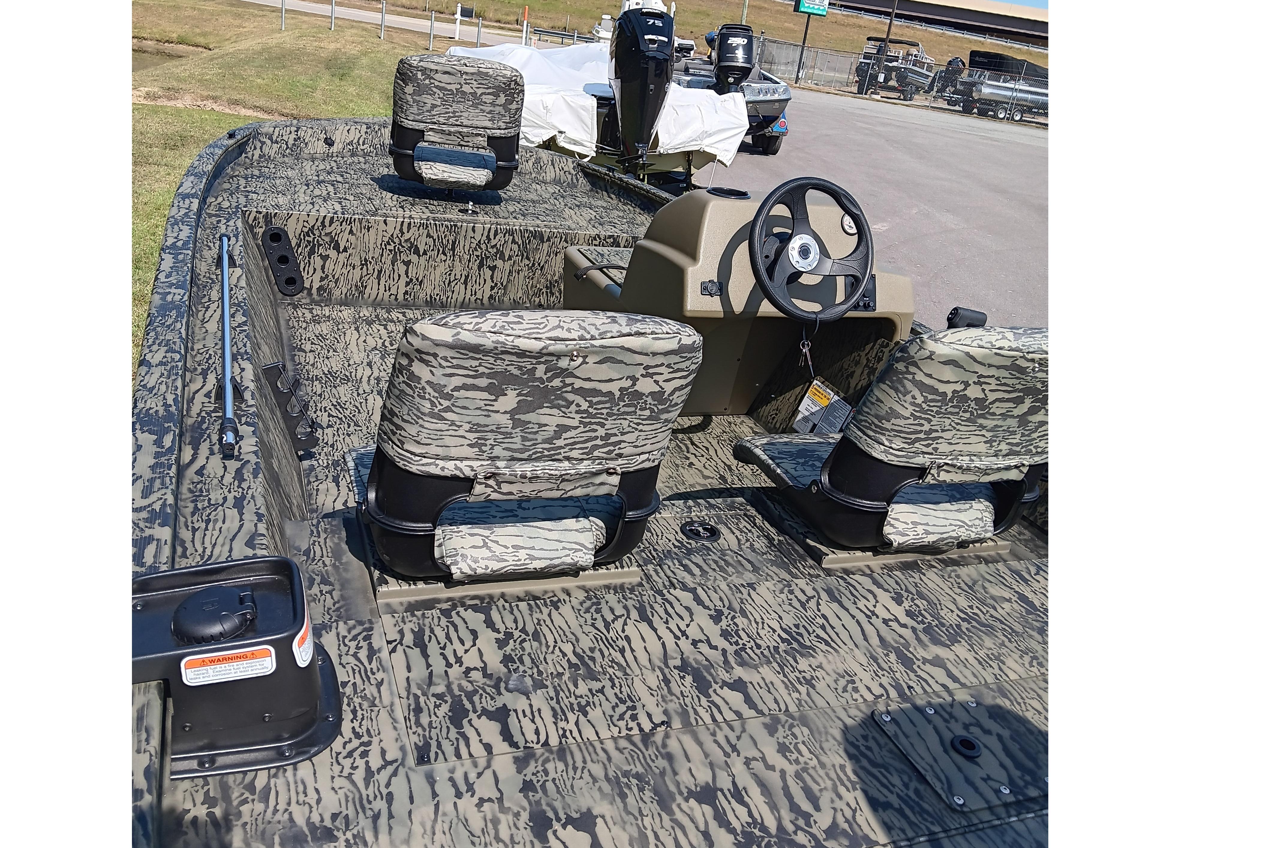 2026 Tracker Grizzly 1754 SC boat with camouflage seats and steering console.