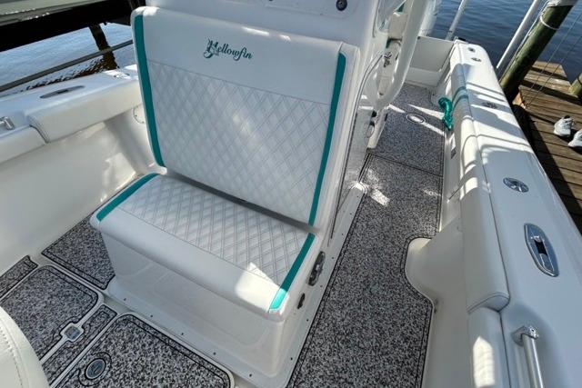2002 Yellowfin 31 Center Console boat interior with white and teal seating.